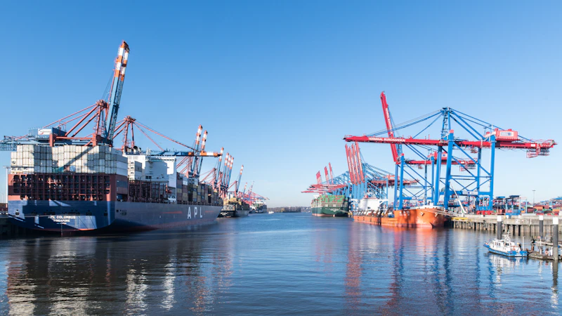 A busy container port with multiple gantry cranes working ships, where terminal appointments are booked