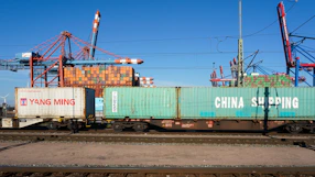 Shipping containers on a train at a port.