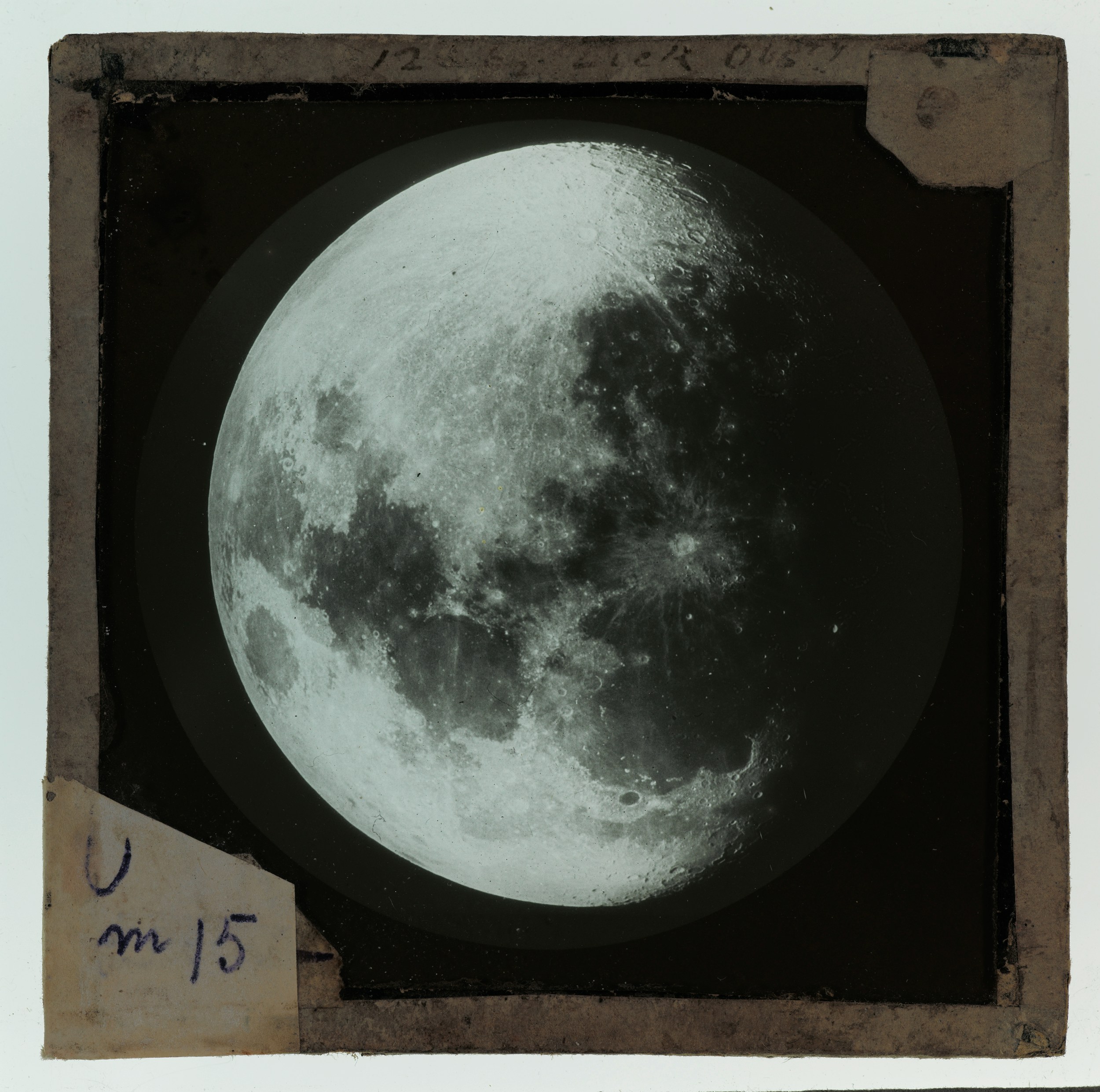 The moon showing craters and a dark shadow