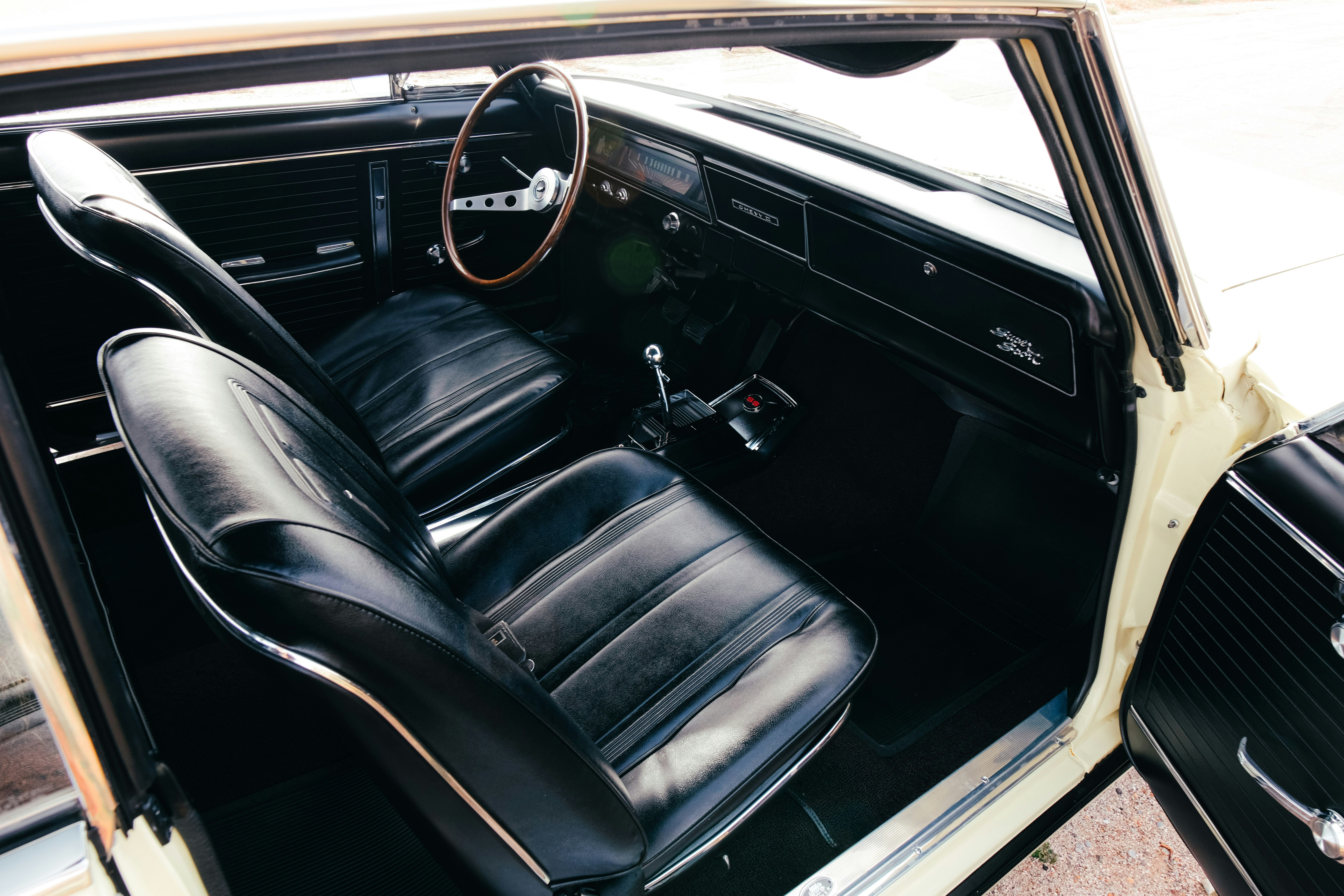 Interior of a vintage car with black seats.