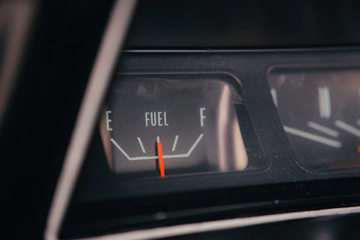 Close-up of a car's fuel gauge showing empty