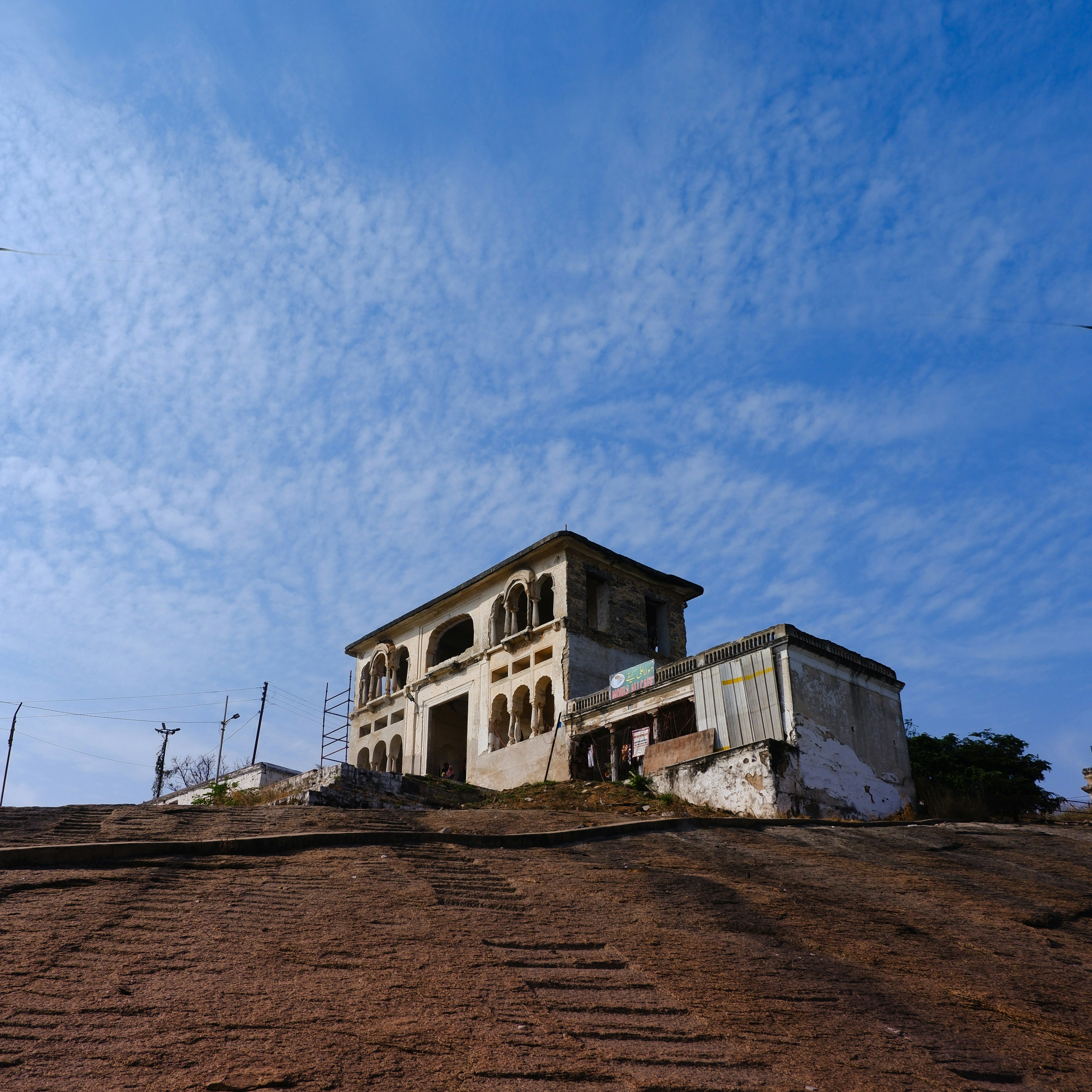 Old building on a rocky hill under blue sky