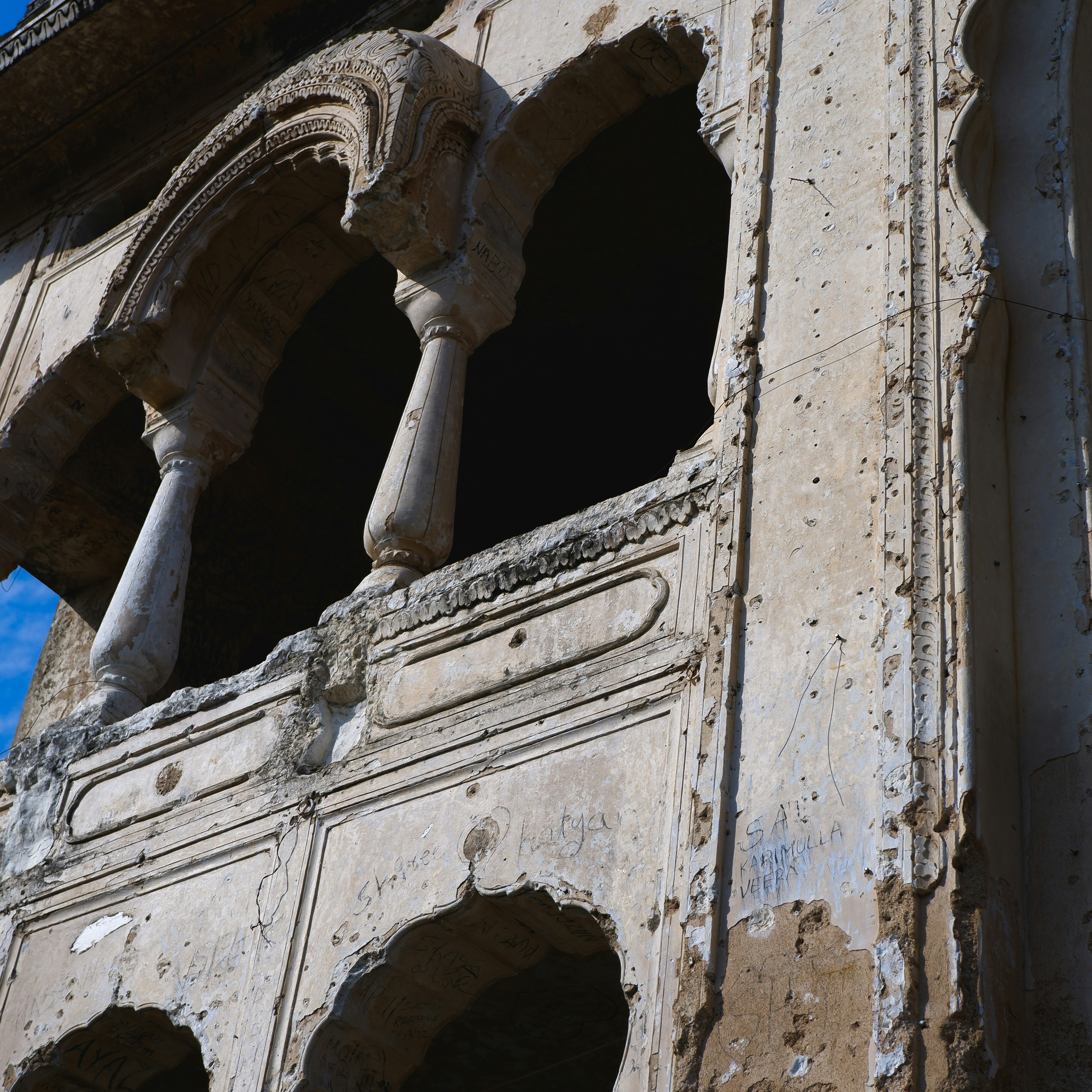 Ruined ornate stone building with arched windows