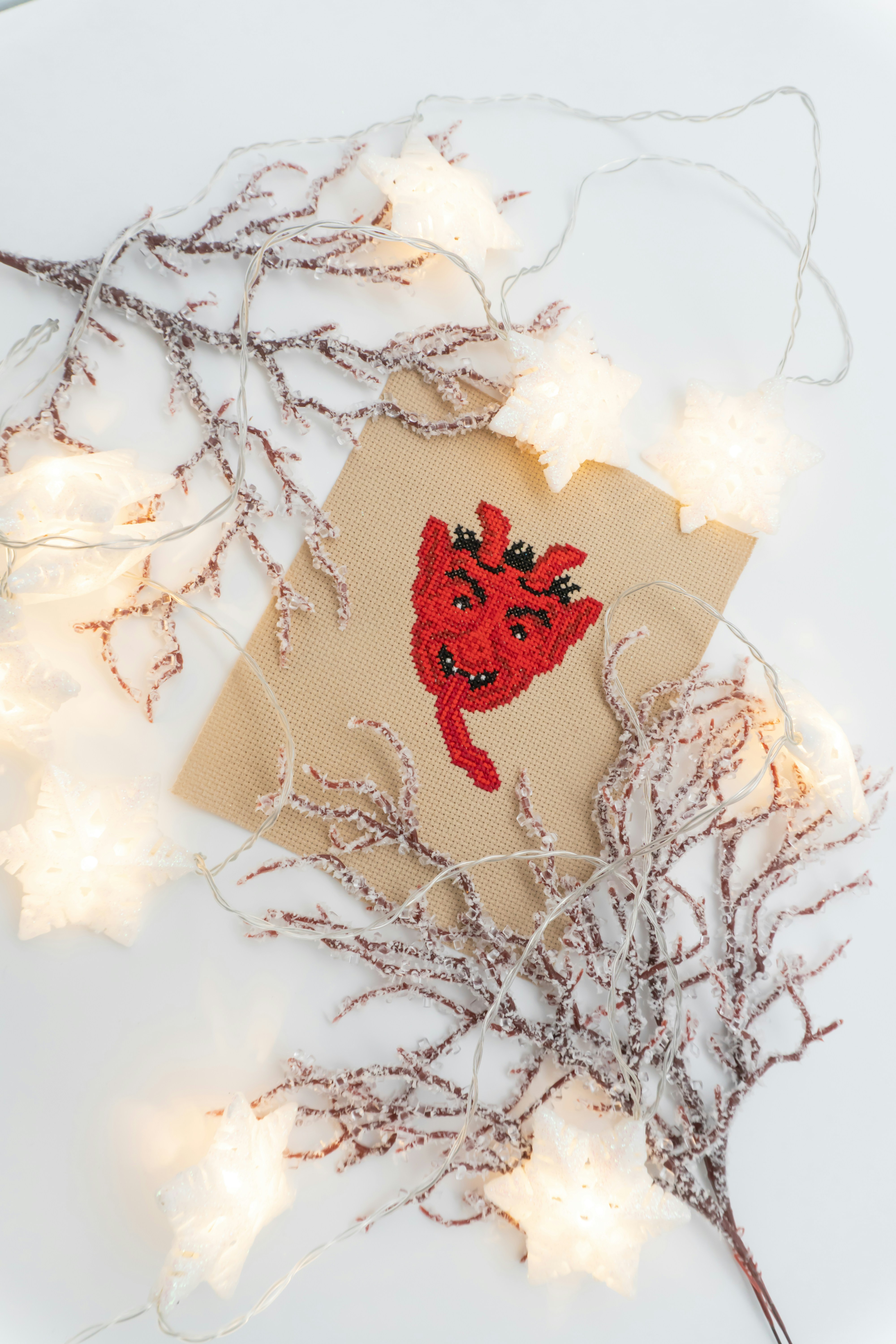 A red devil drawing on a card with lights.