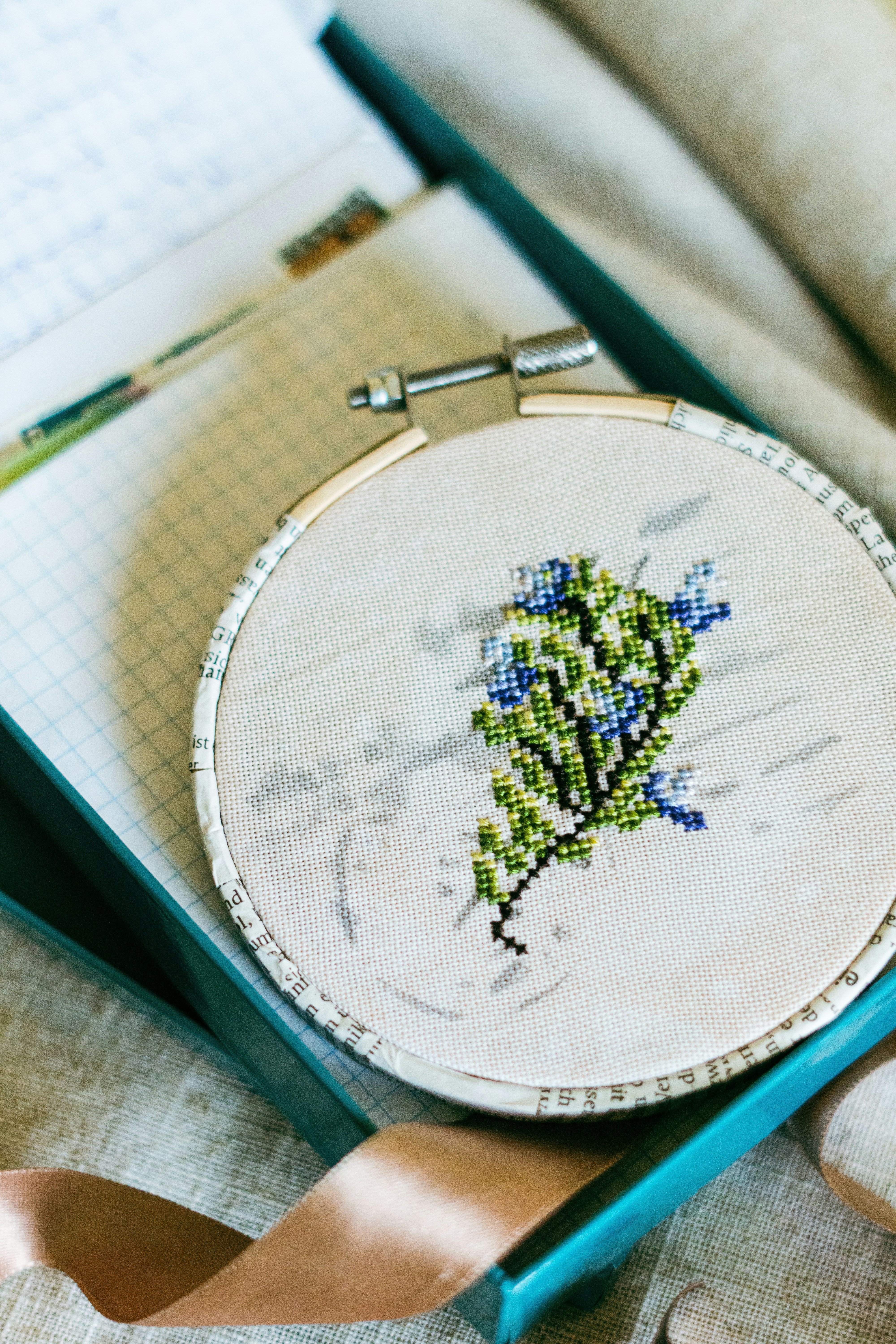 Cross-stitch embroidery of a floral bouquet in hoop.