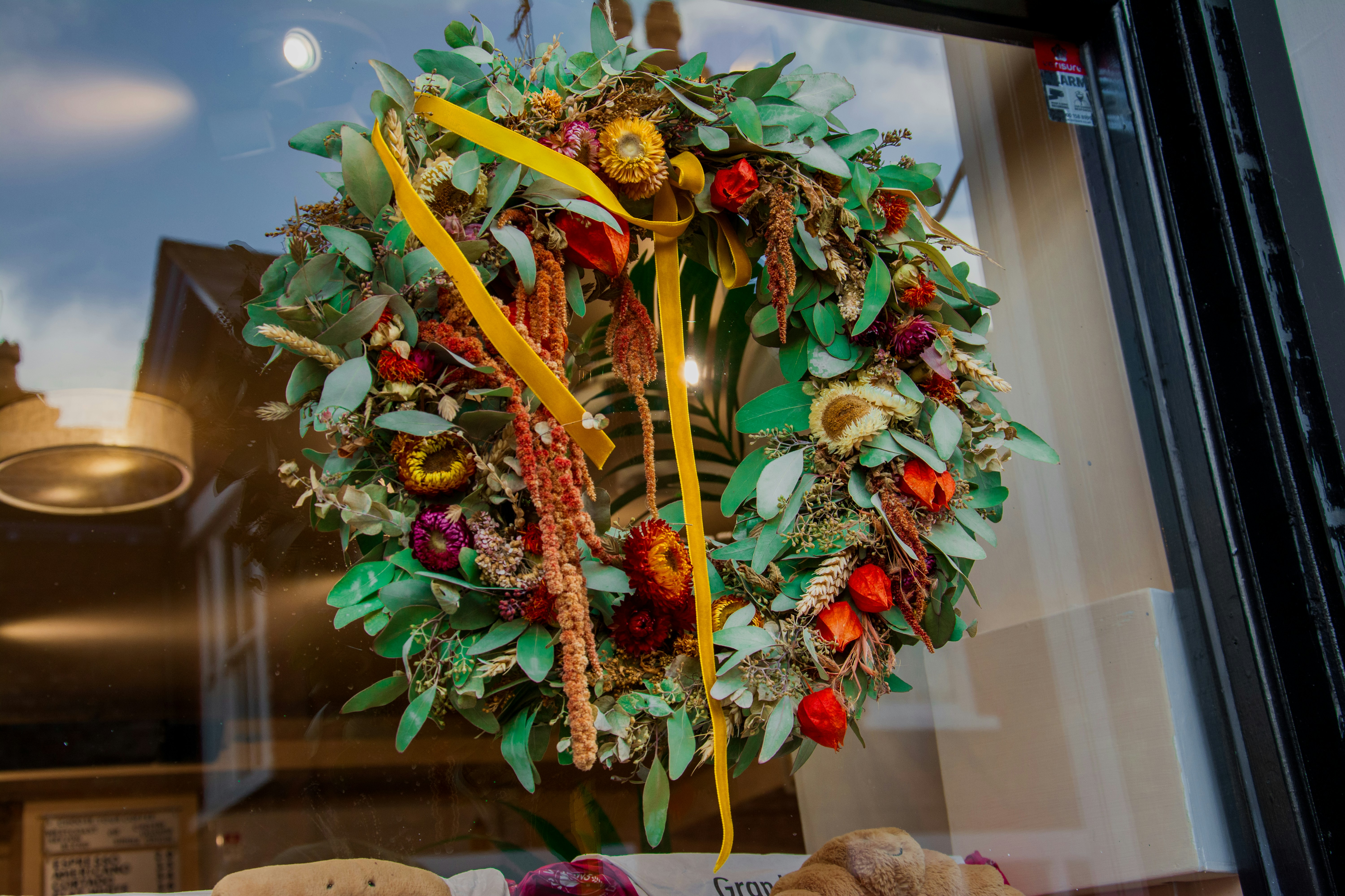 A decorative wreath with dried flowers and fruits.