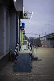 Accessible entrance ramp with stairs and handrails