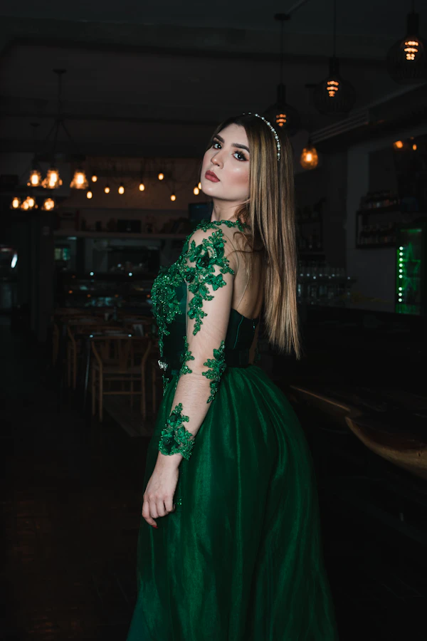 Elegant green evening dress with lace detail, an example of black-tie-optional attire for guests