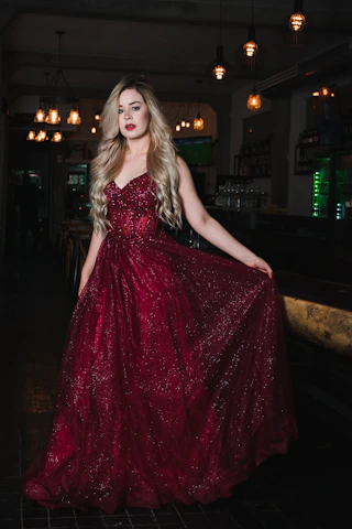 Woman in a sparkling red gown at a bar
