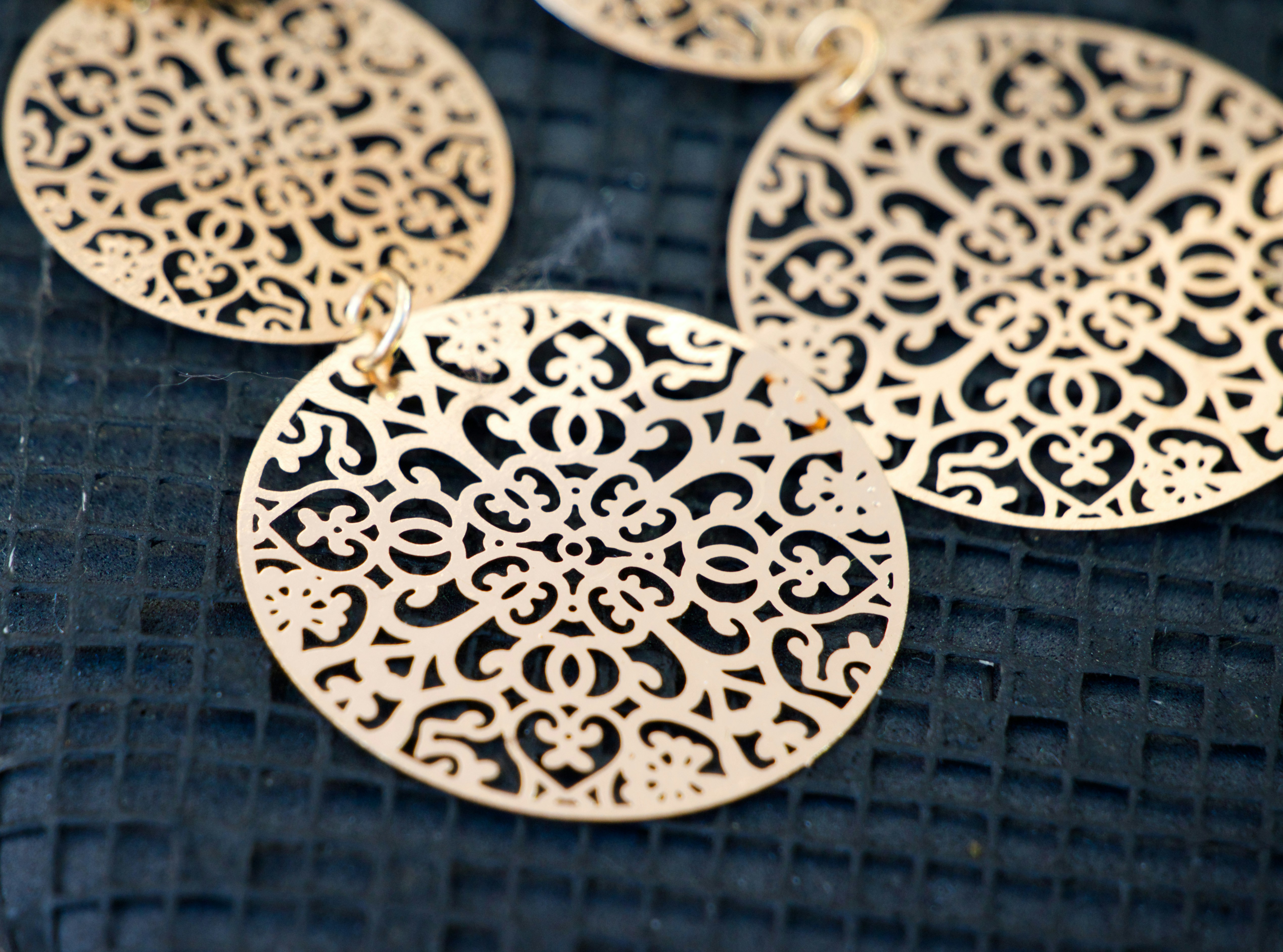 Ornate gold filigree medallions on dark background
