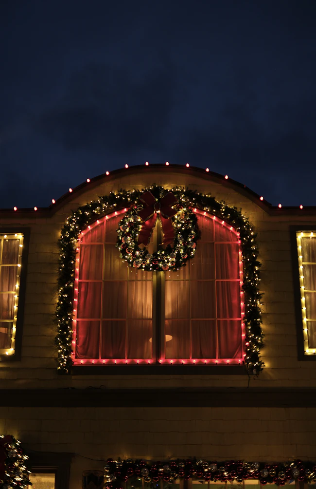 Home exterior with seasonal wreath and lights