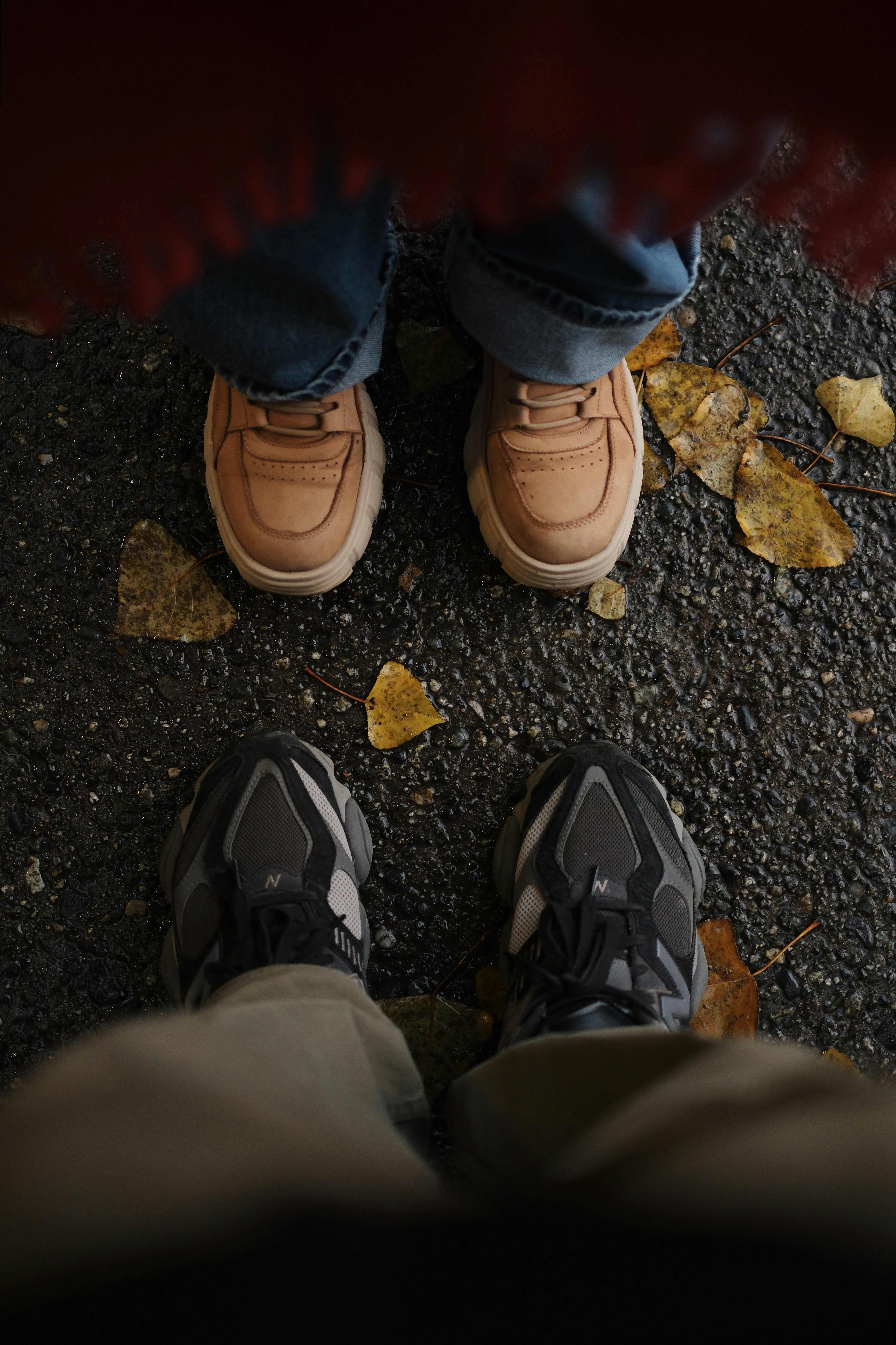 Two pairs of shoes on a gravel path