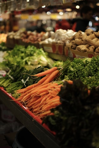 Fresh carrots and leafy greens at a market