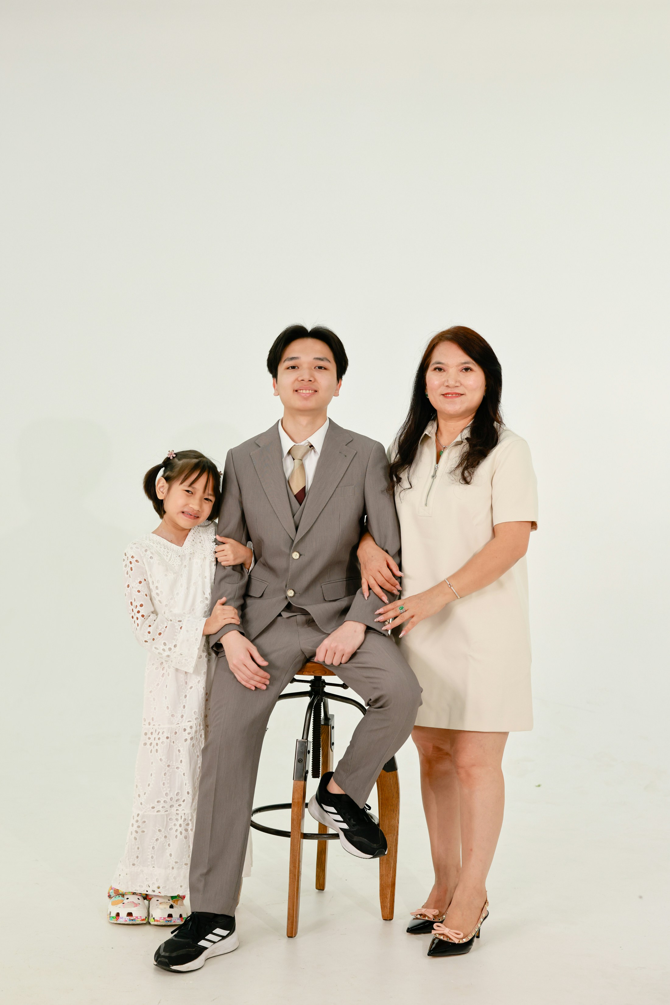 Family posing for a studio portrait on white background