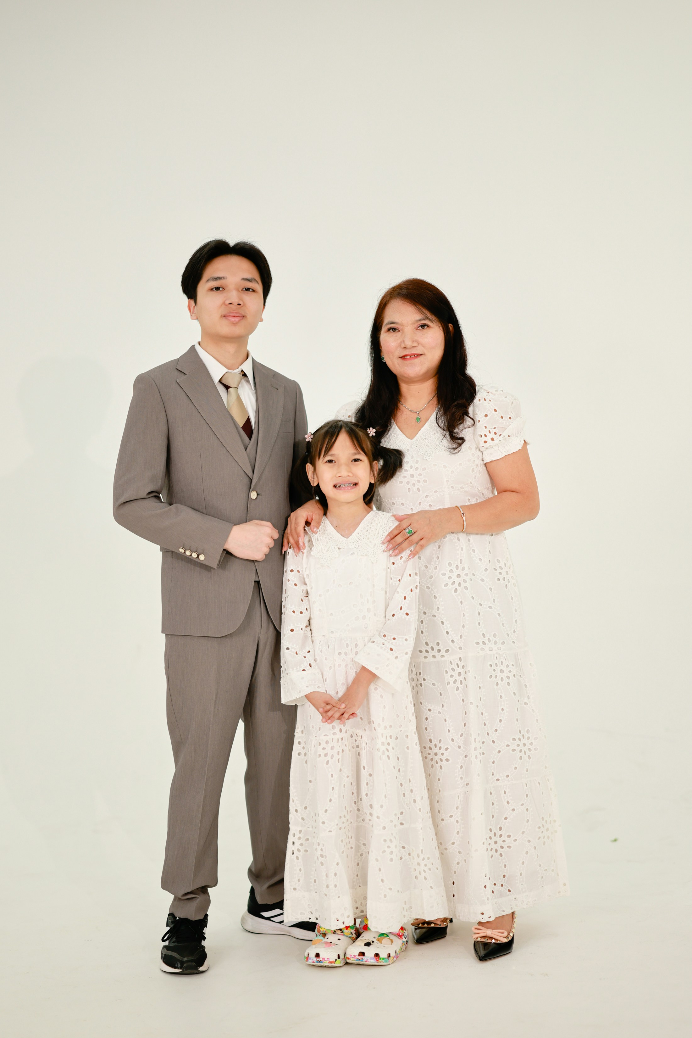 A mother and her two children posing for a portrait.