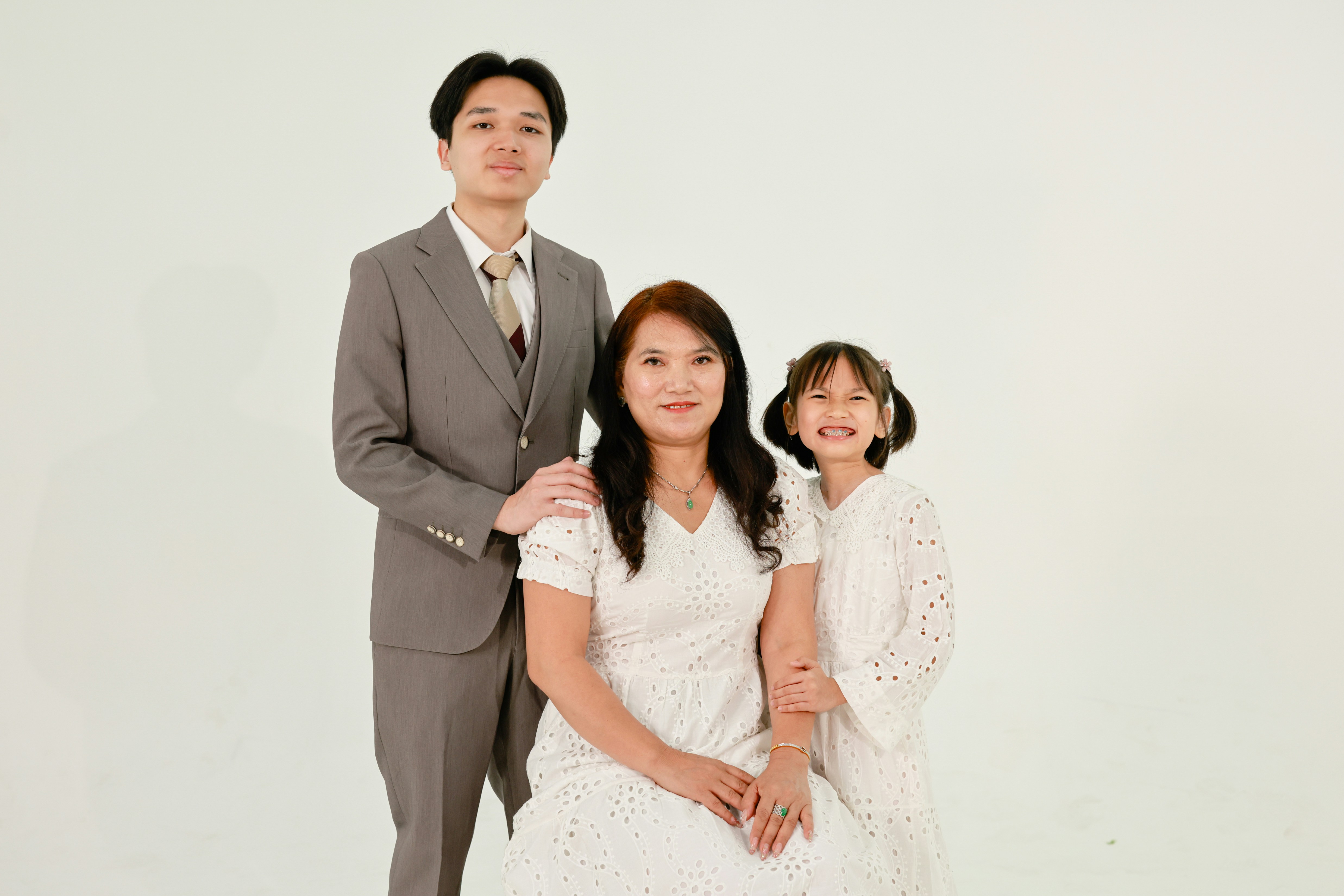 Family posing for a studio portrait against white background