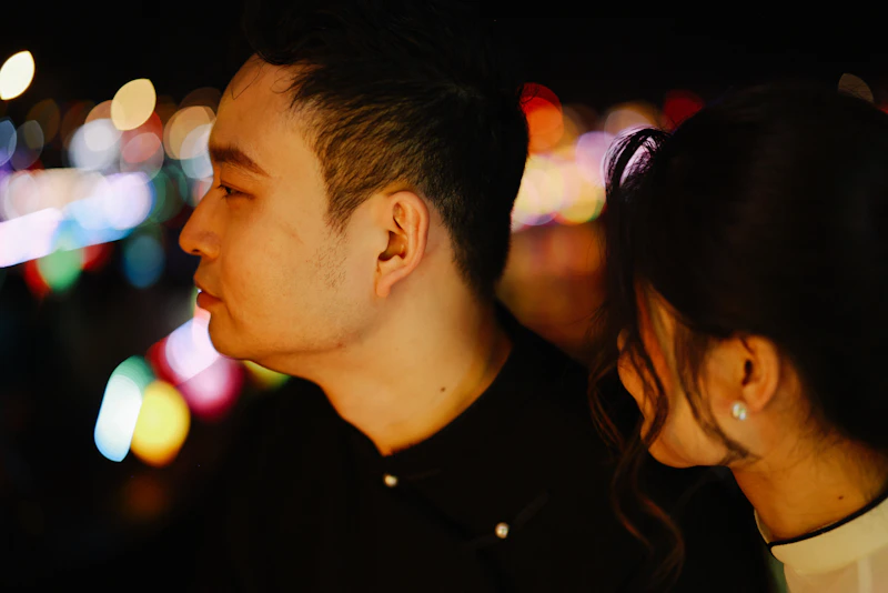 Couple looking out at city lights at night