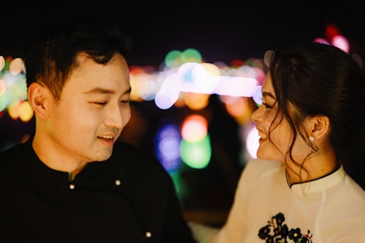 Couple looking at each other with bokeh lights