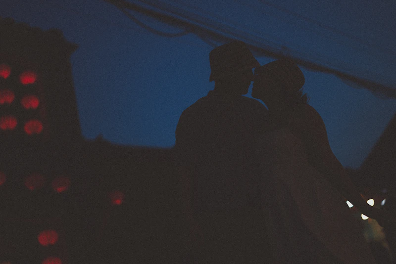 Couple silhouettes against twilight sky