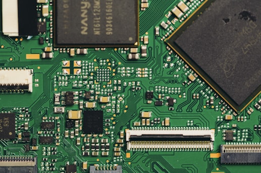 Close-up view of a green circuit board with components.