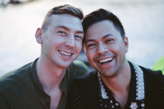 Two men smiling together outdoors