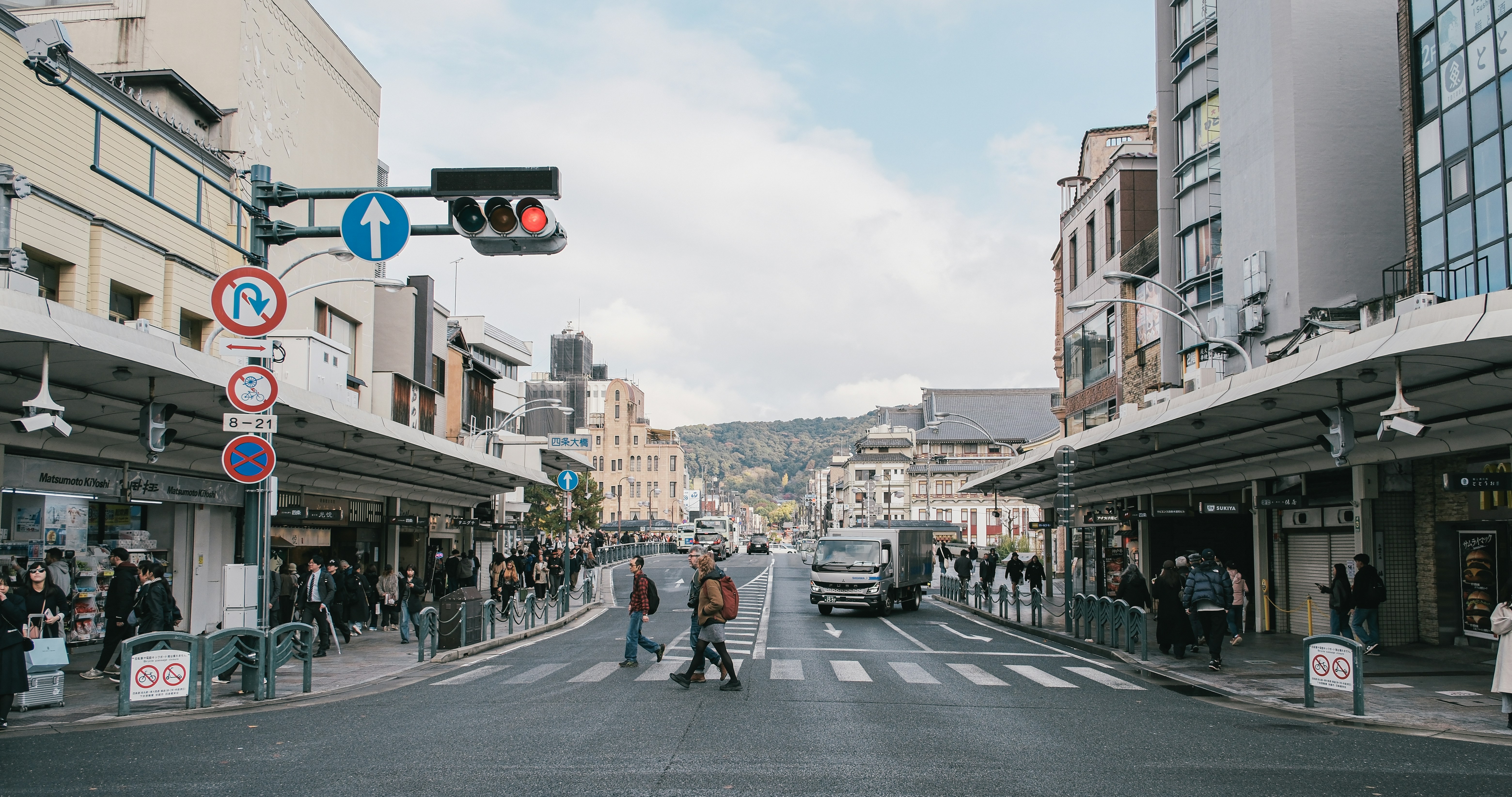 People crossing a street in a japanese town.