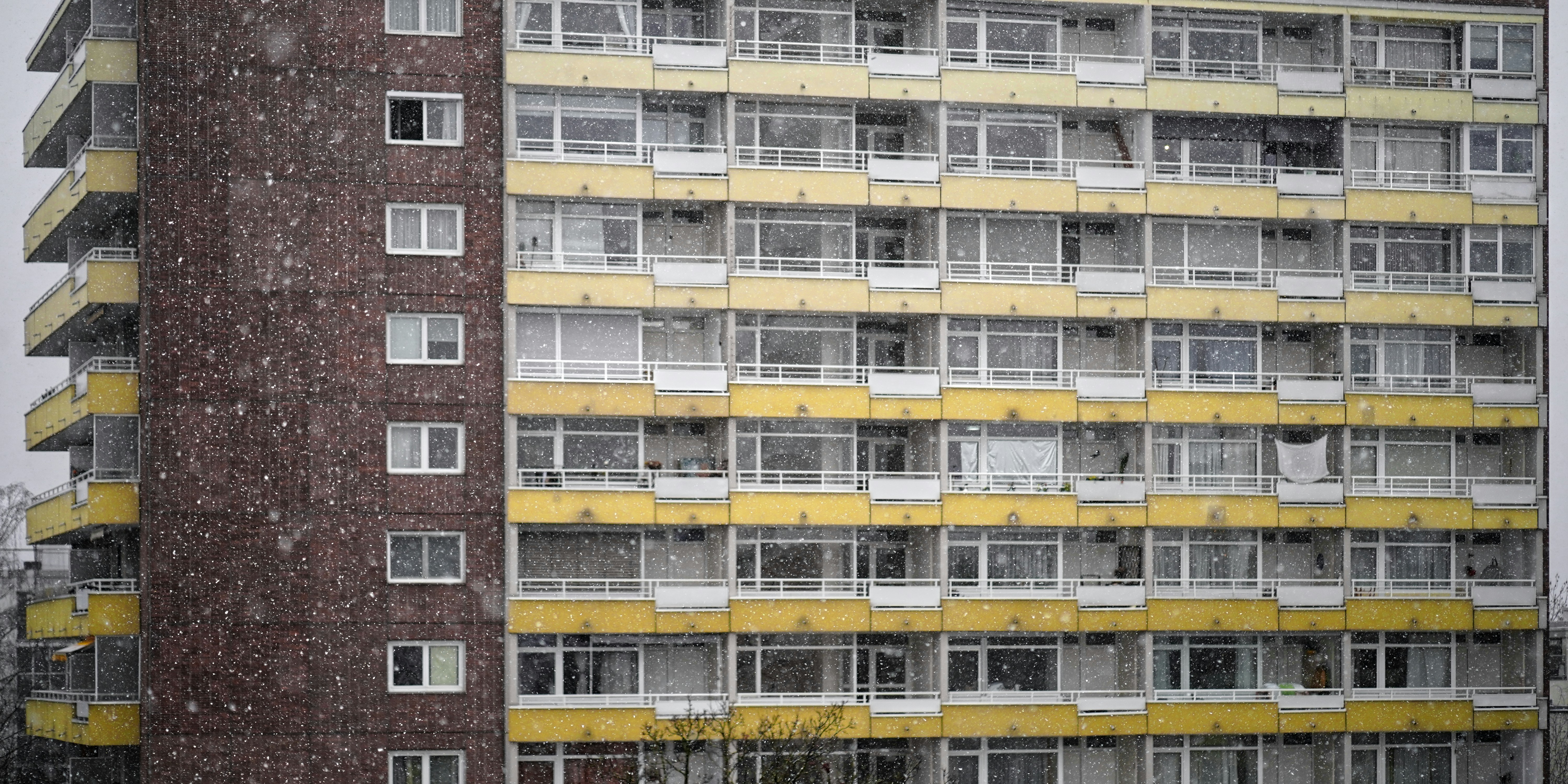 Tall apartment building with yellow and brown facade