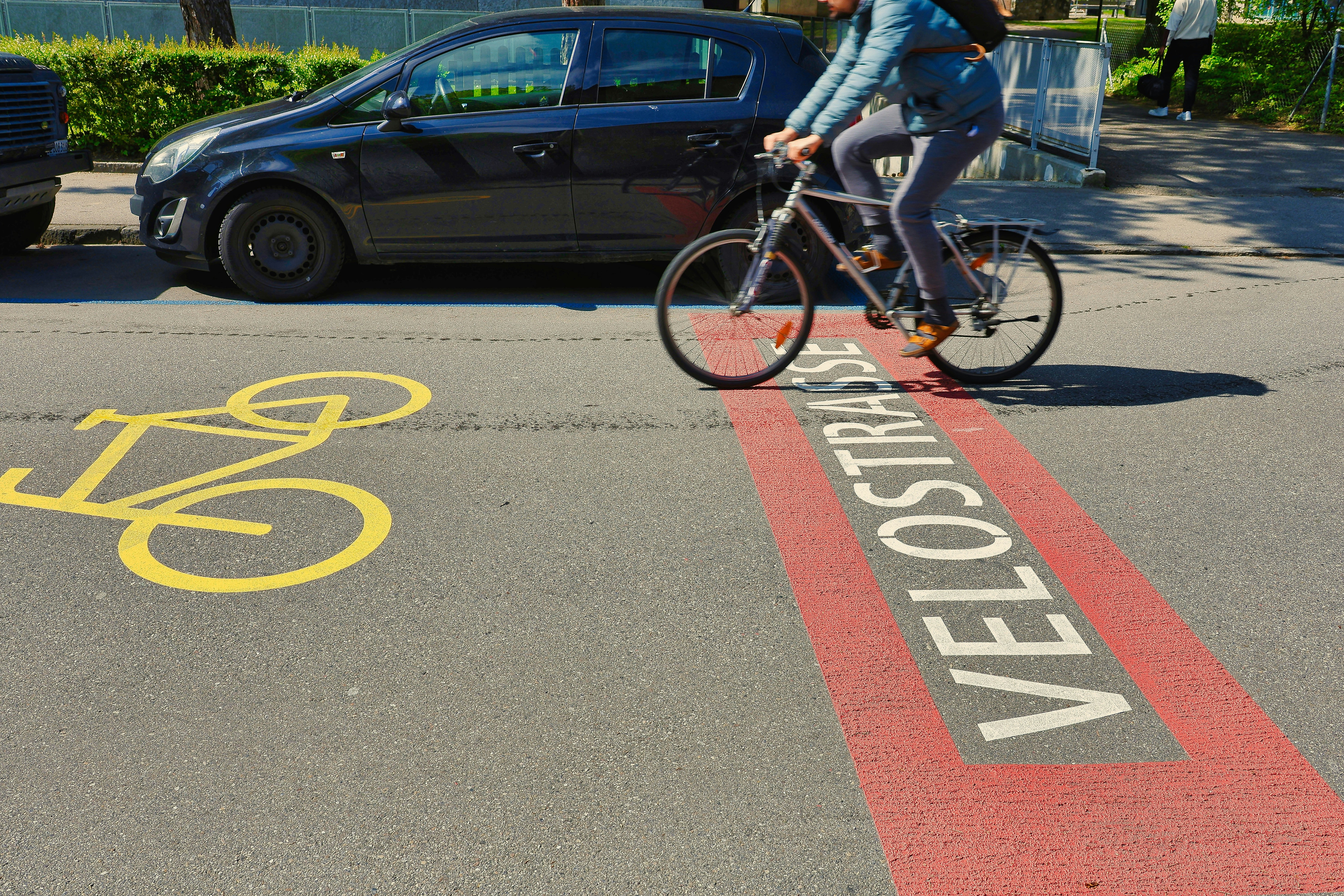Person riding bicycle on a street with bike lane.
