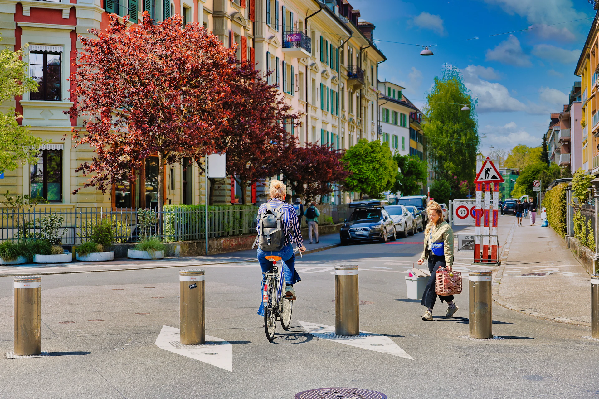 People cycling and walking on a city street