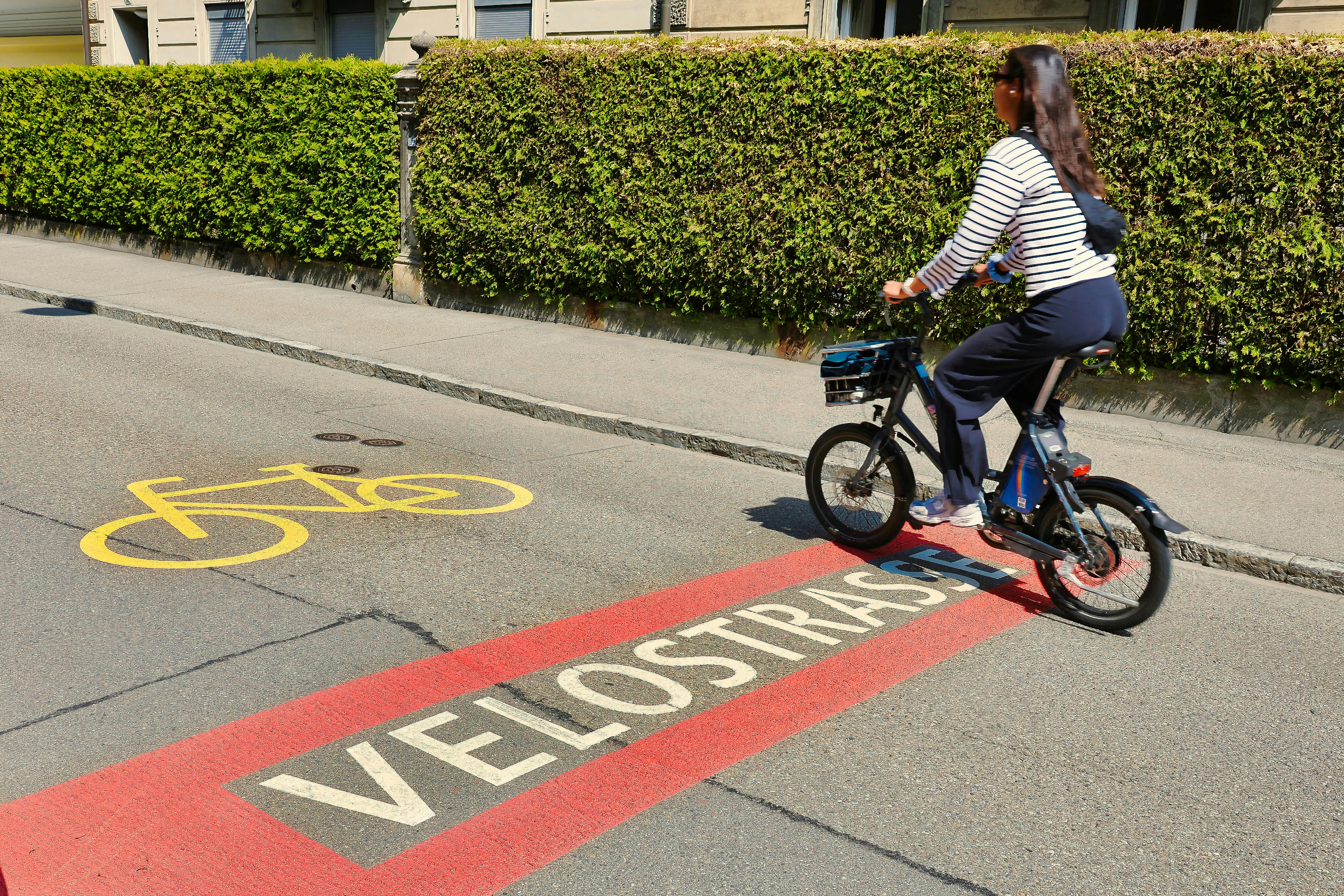 Woman riding a bicycle on a bike lane.