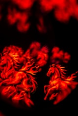 Two horses made of fire running
