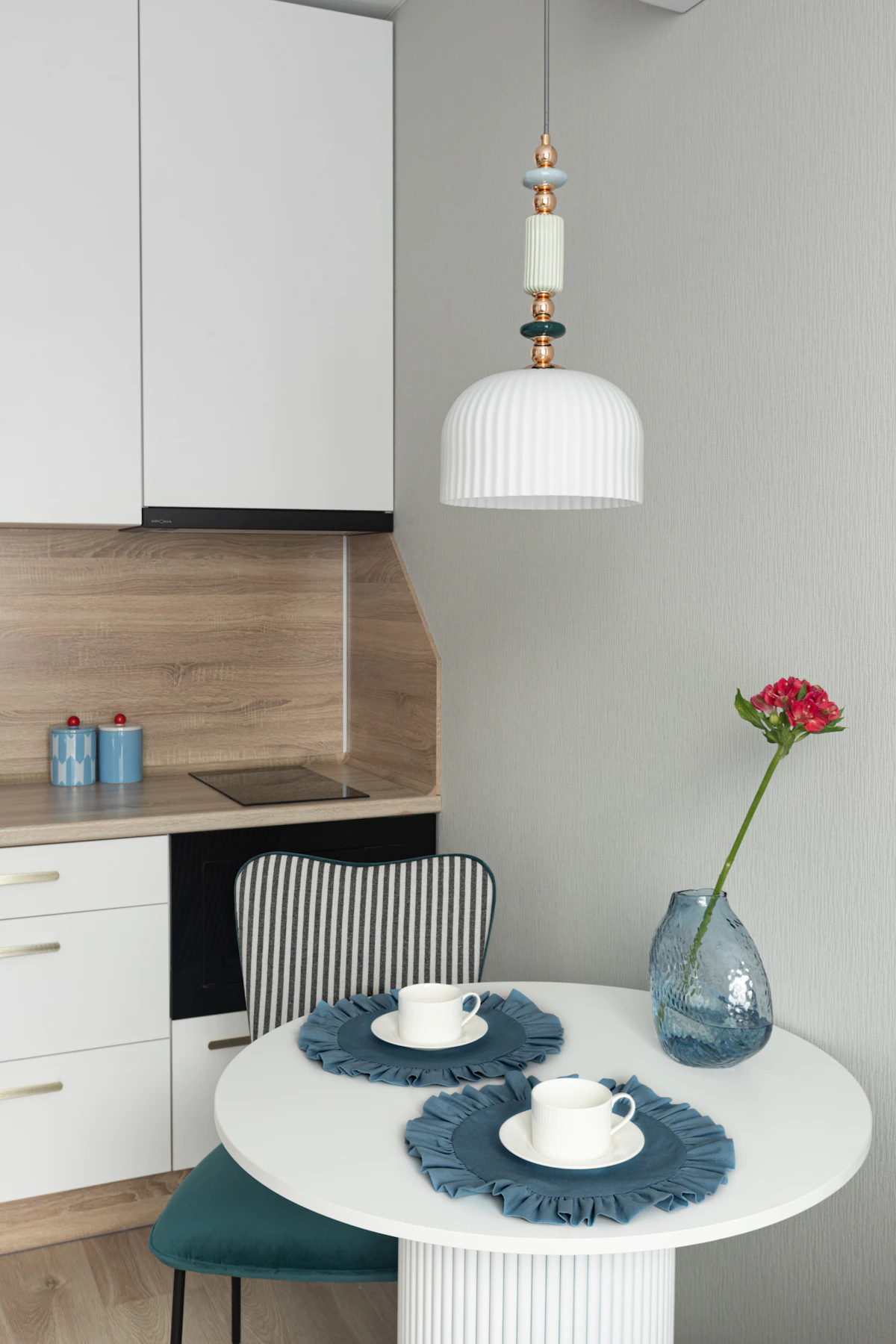 Fold-down table serving as dining and prep space in a tiny kitchen