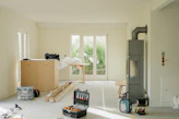 Room under renovation with tools and furniture.