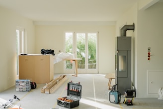 Room under renovation with tools and furniture.