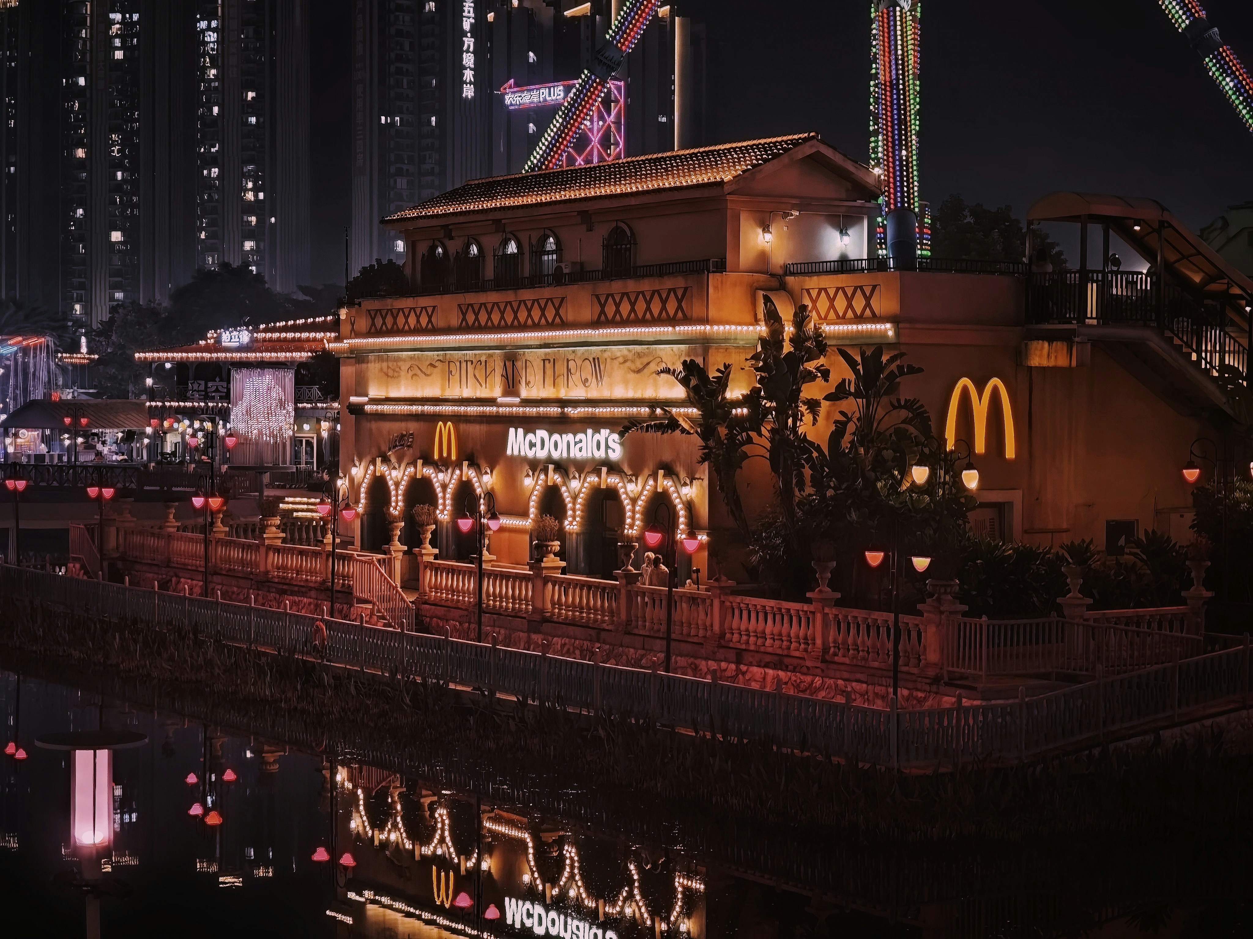 Mcdonald's restaurant illuminated at night by a river