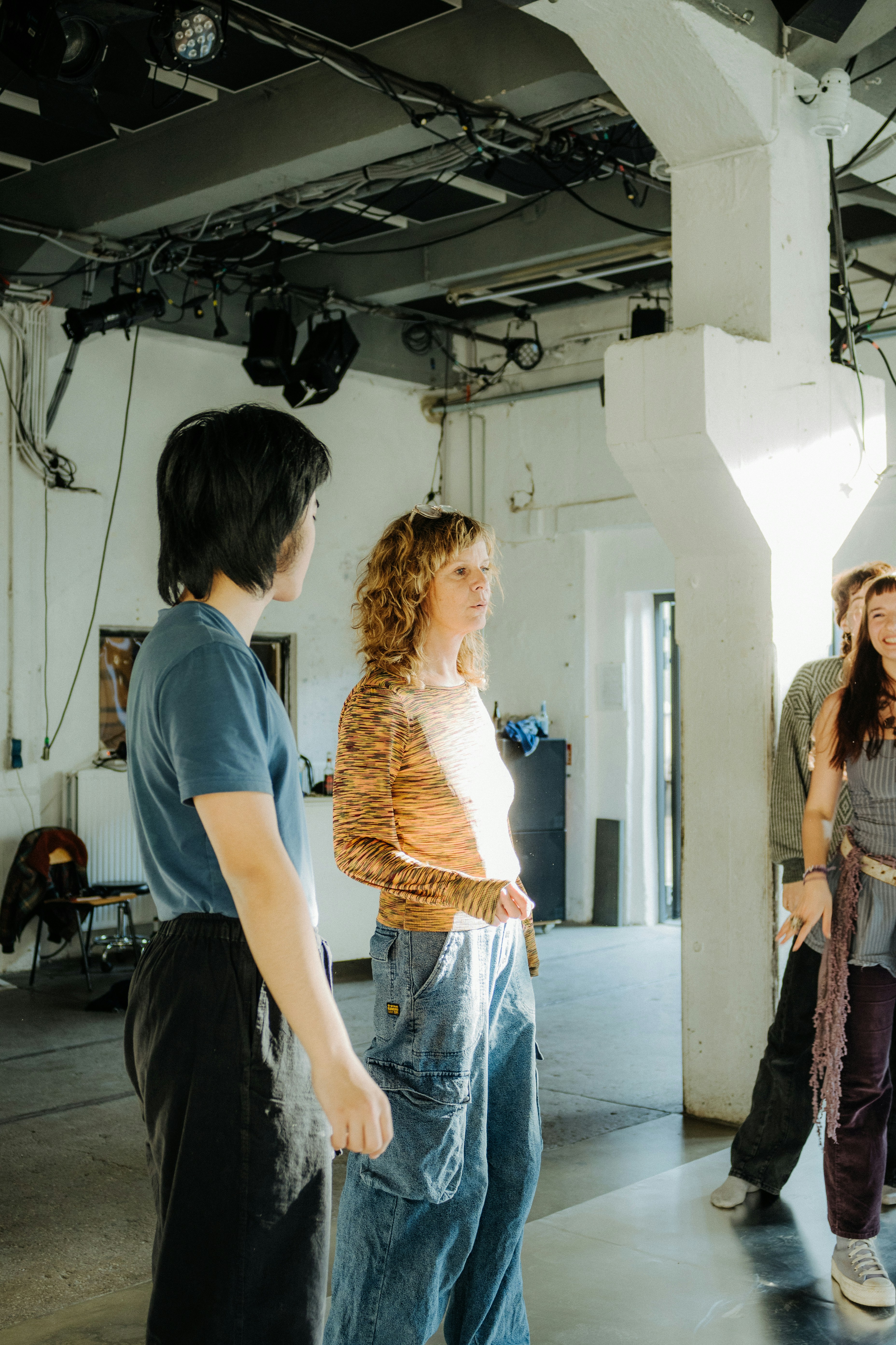 People gathered in a large, industrial-style room.