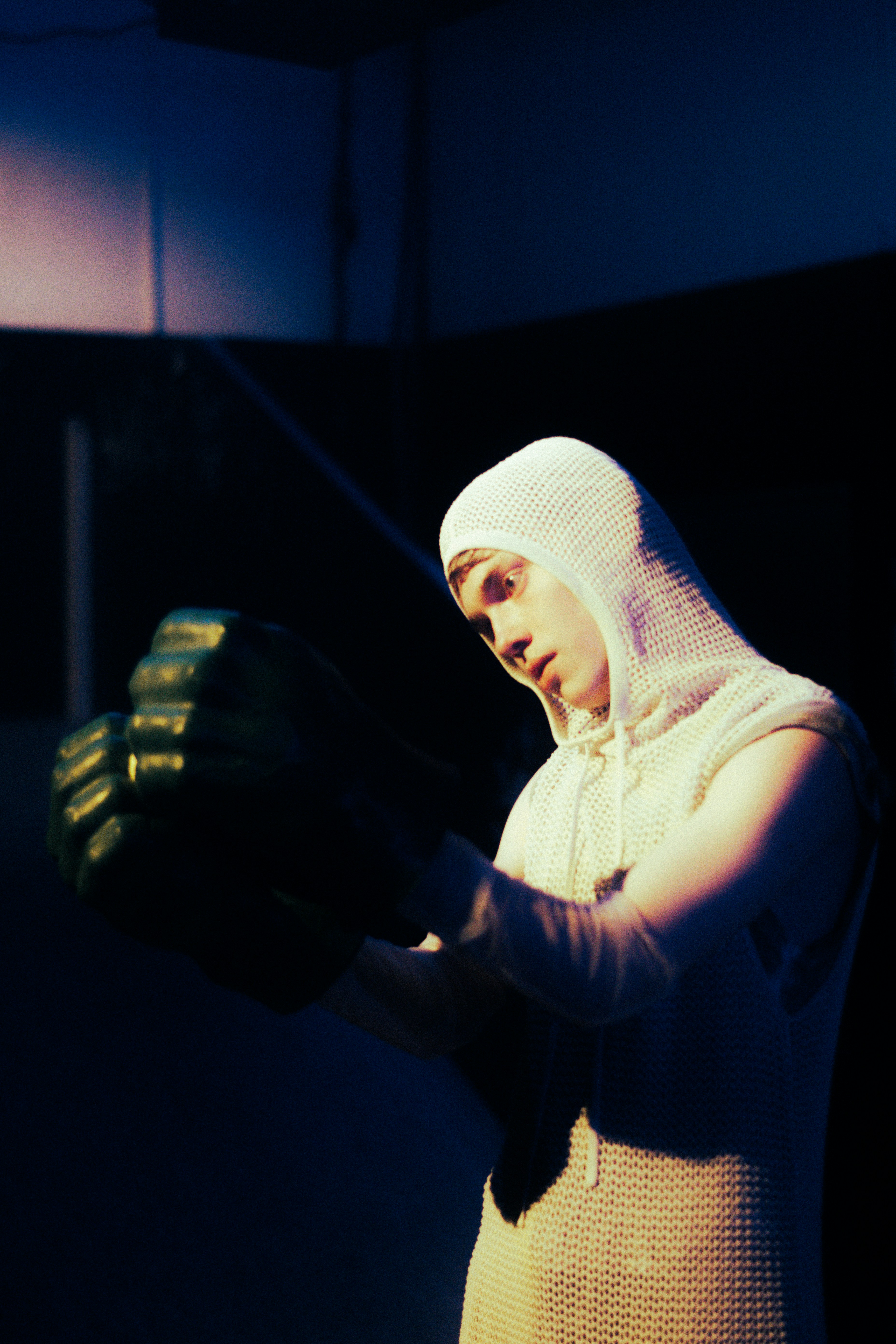 A person looking thoughtful in a gym setting.