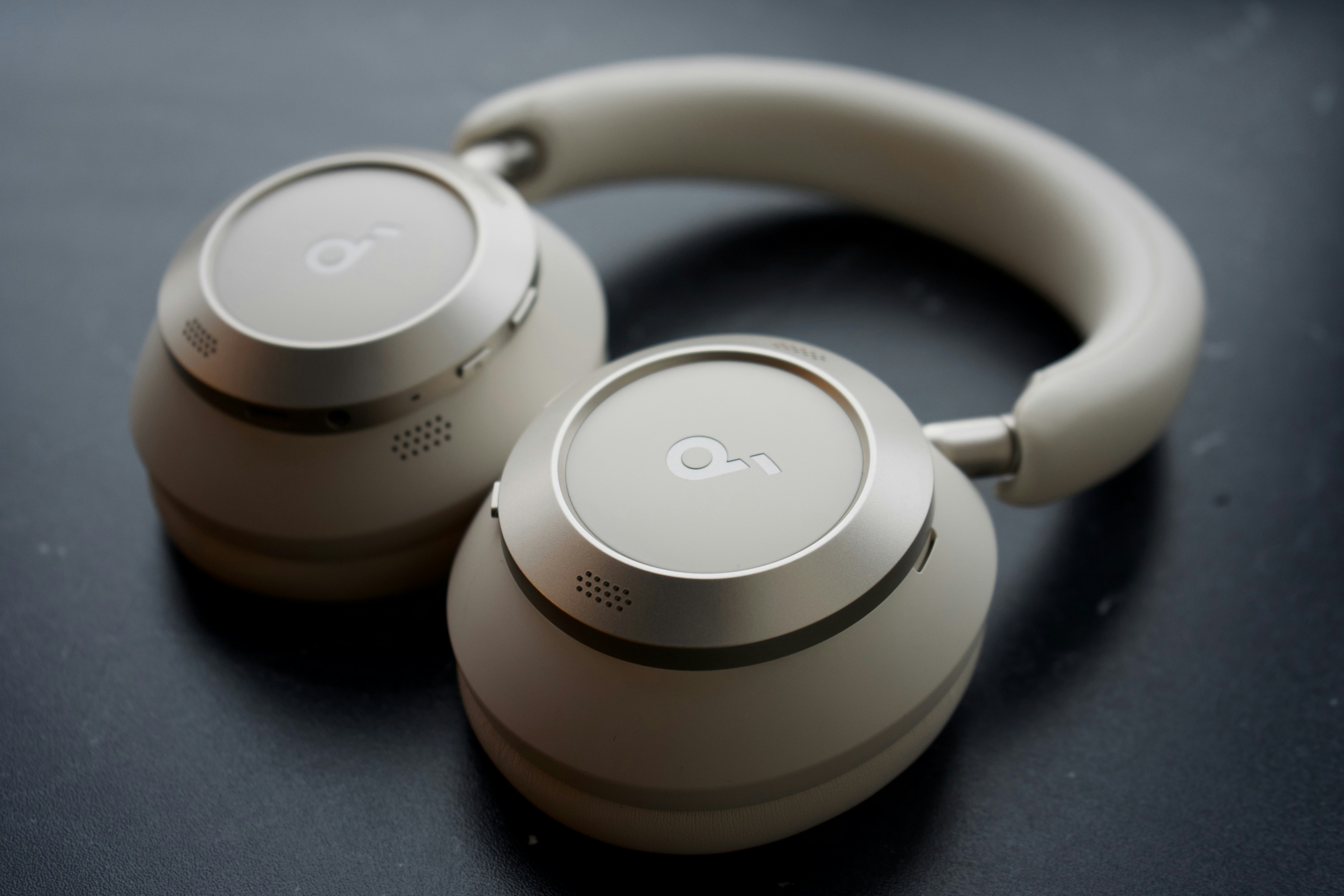 A pair of modern white over-ear headphones.