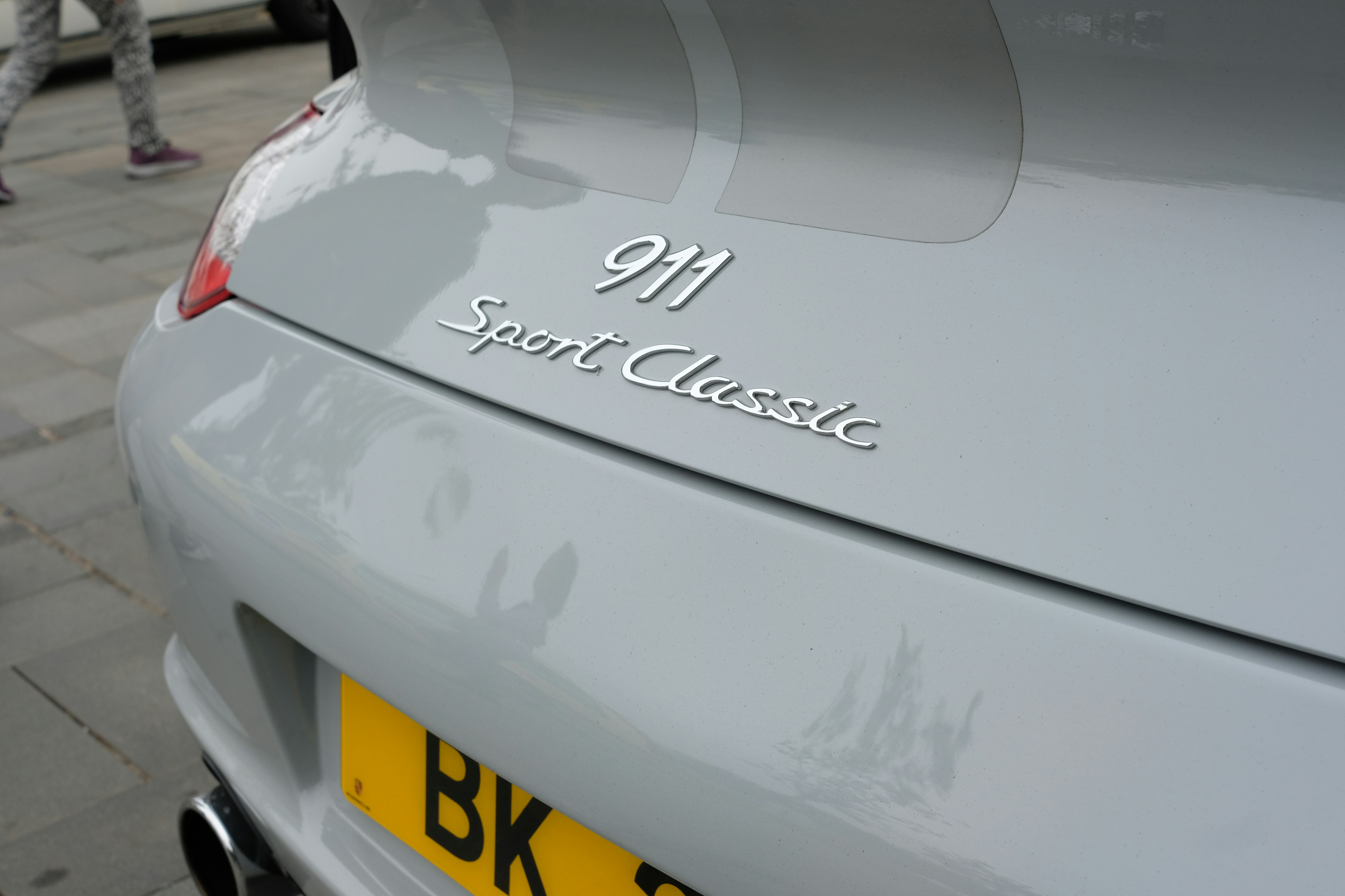 Grey porsche 911 sport classic with yellow license plate