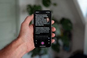 Hand holding phone displaying teleprompter app