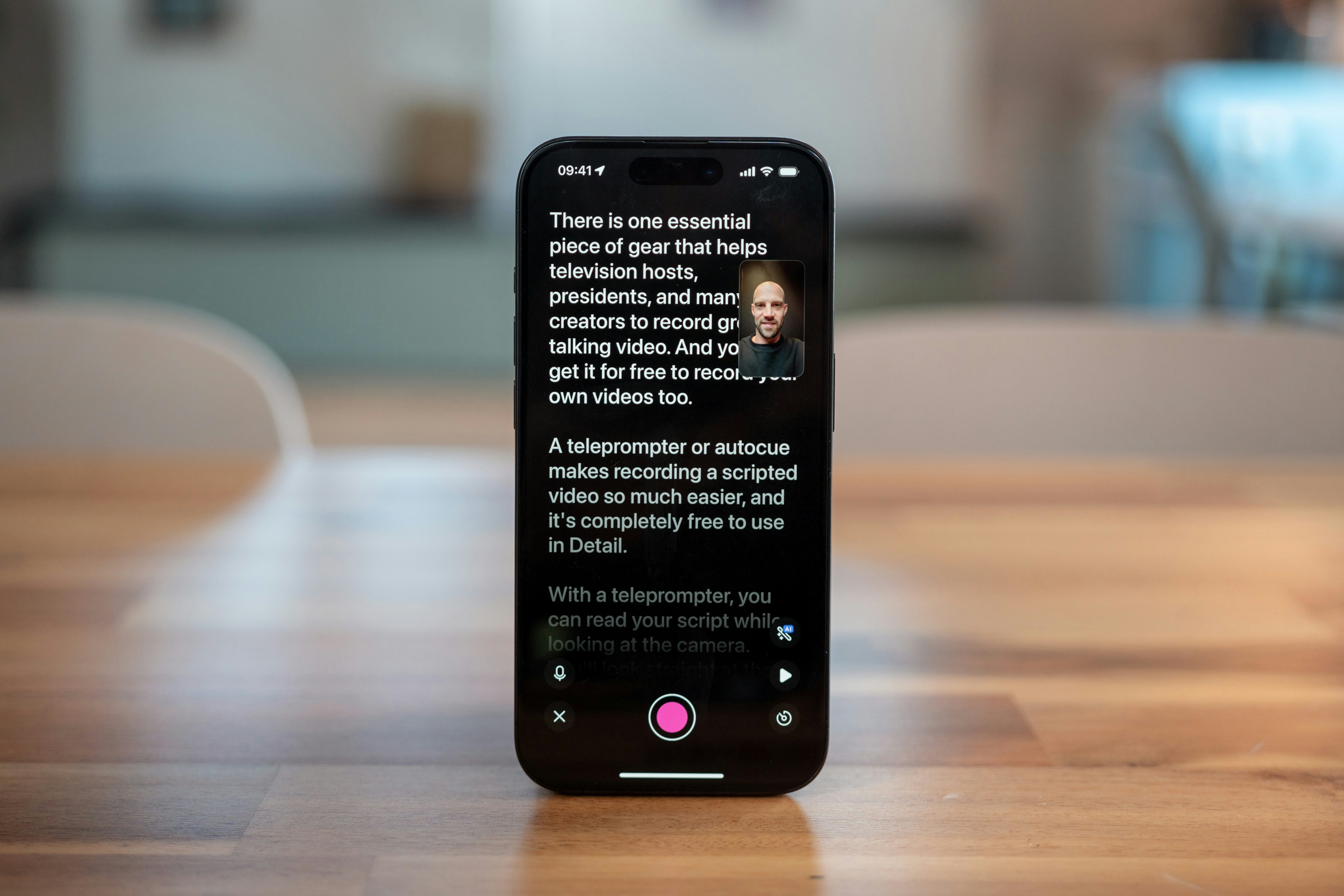 Smartphone displaying teleprompter app with recording button.