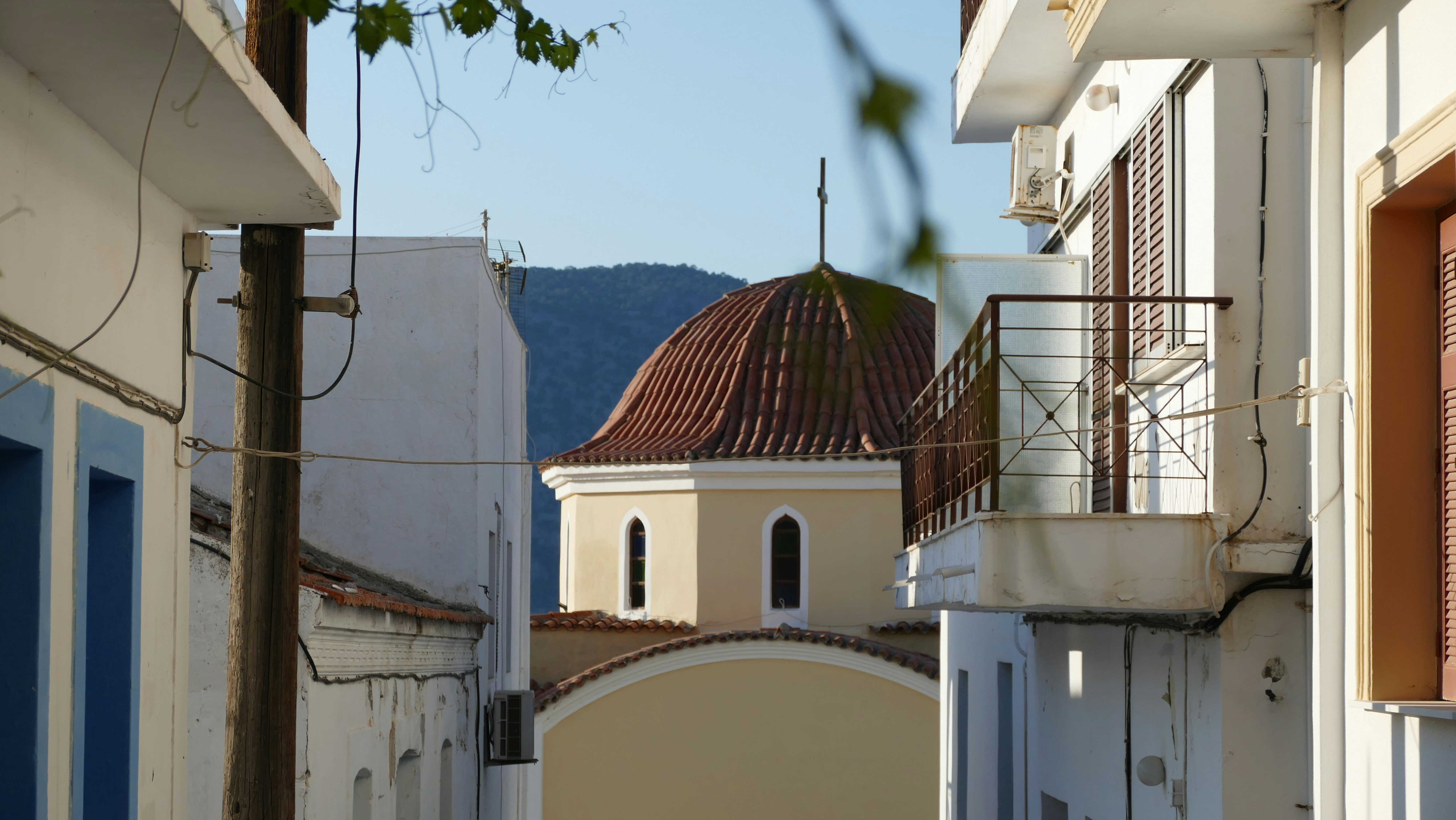 Dome of a building seen between white walls