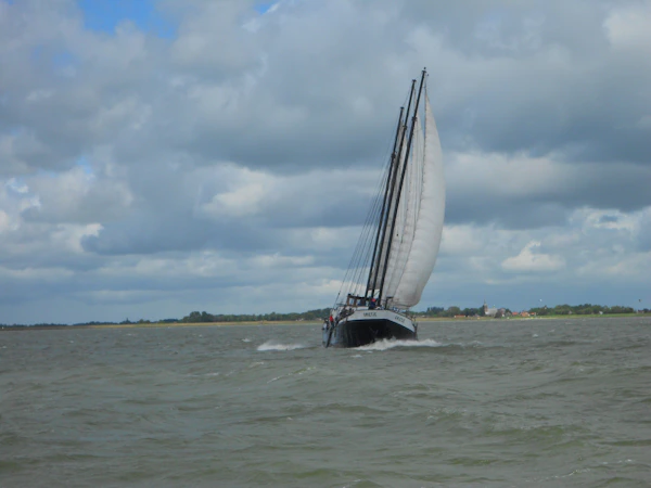 Sailboat on downwind passage across open Pacific waters