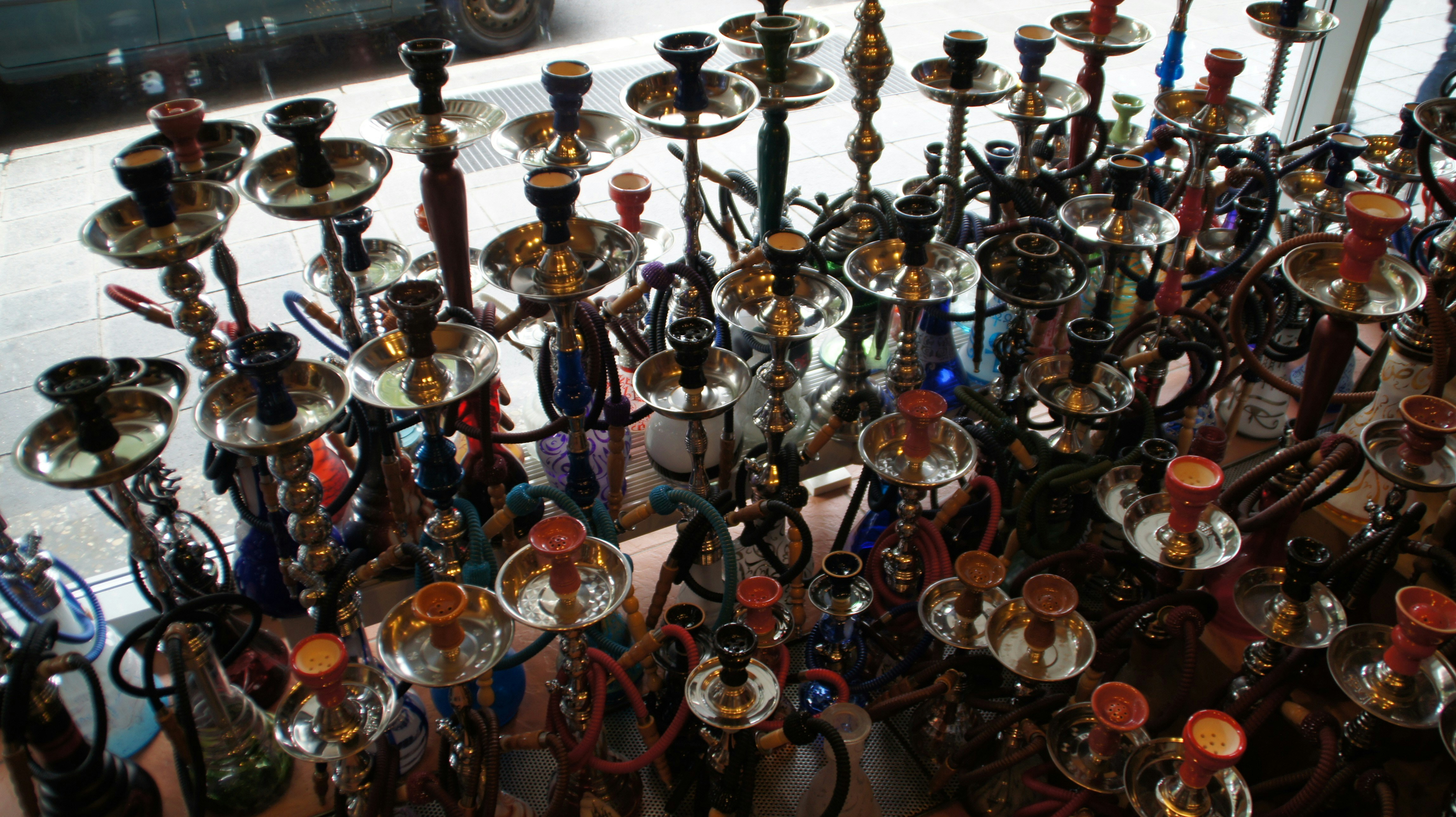 Collection of many ornate hookahs displayed together