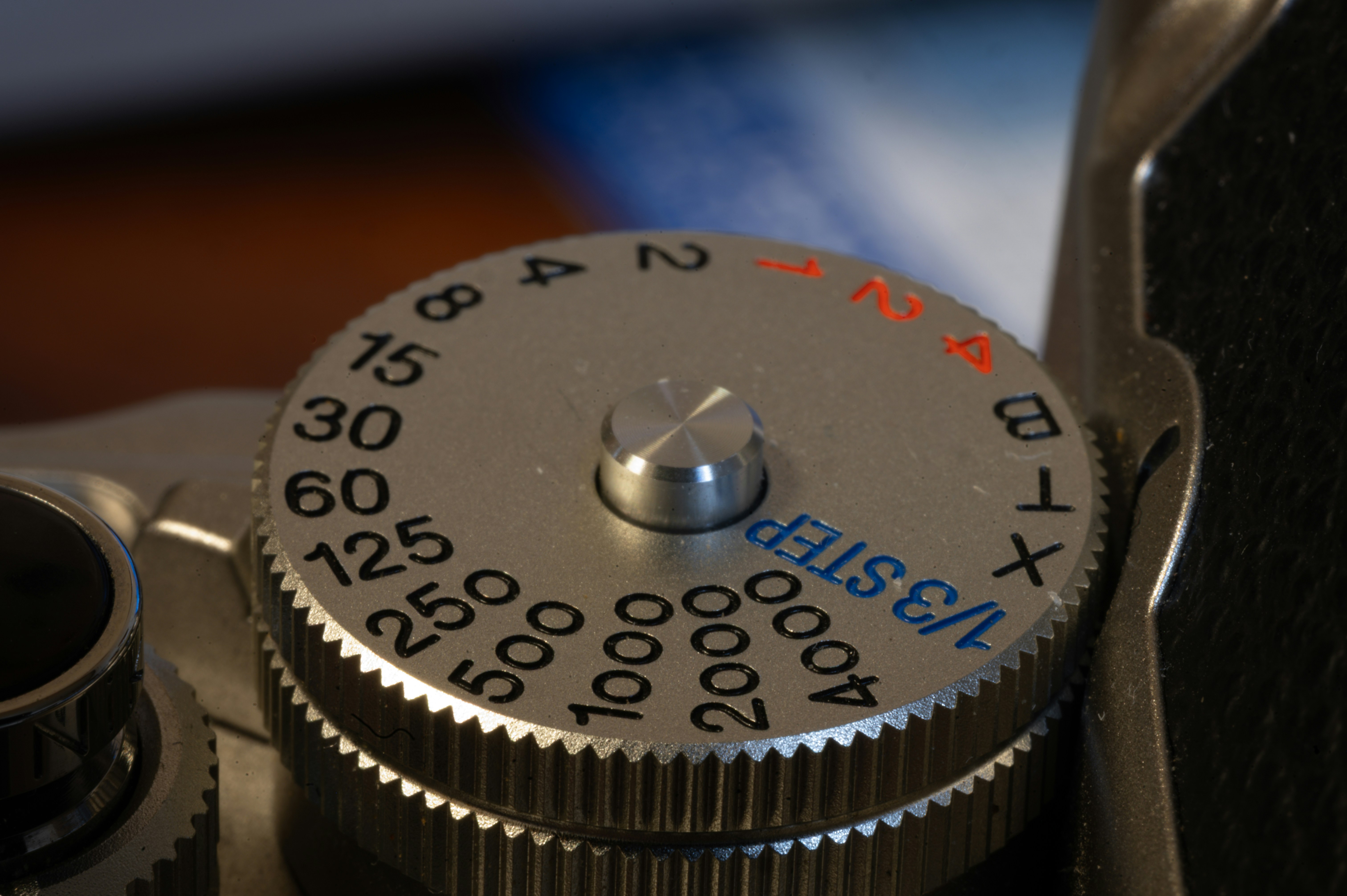 Close-up of a vintage camera's shutter speed dial.