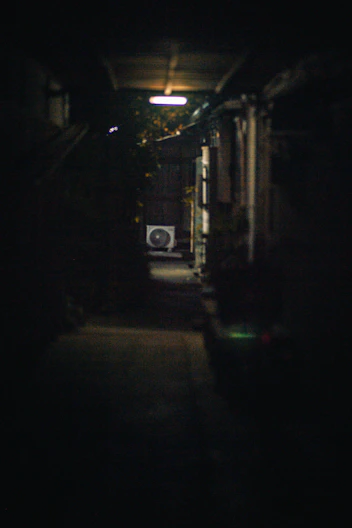 Dark alleyway with an air conditioning unit visible
