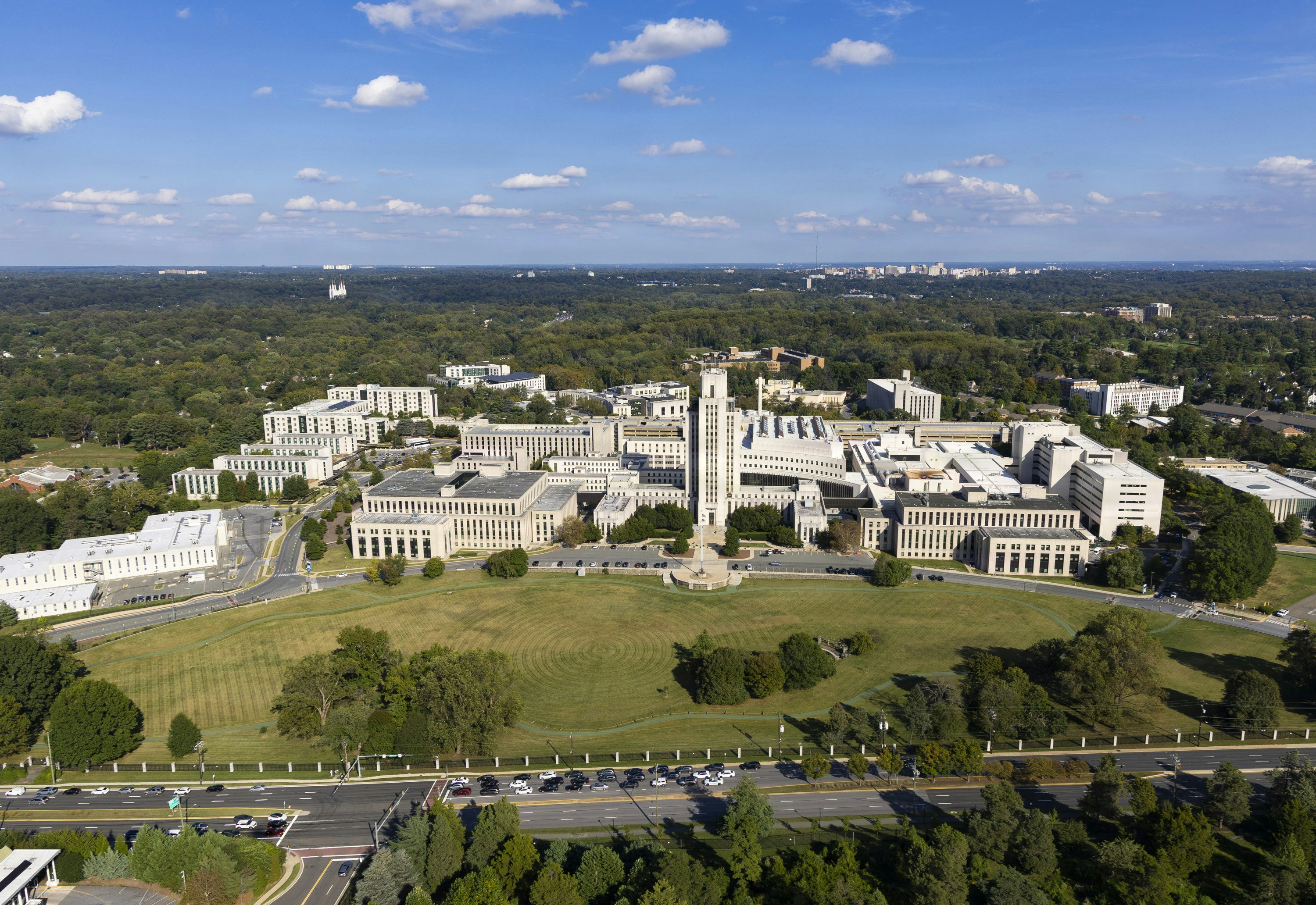 Large institutional buildings surrounded by green lawns and trees.