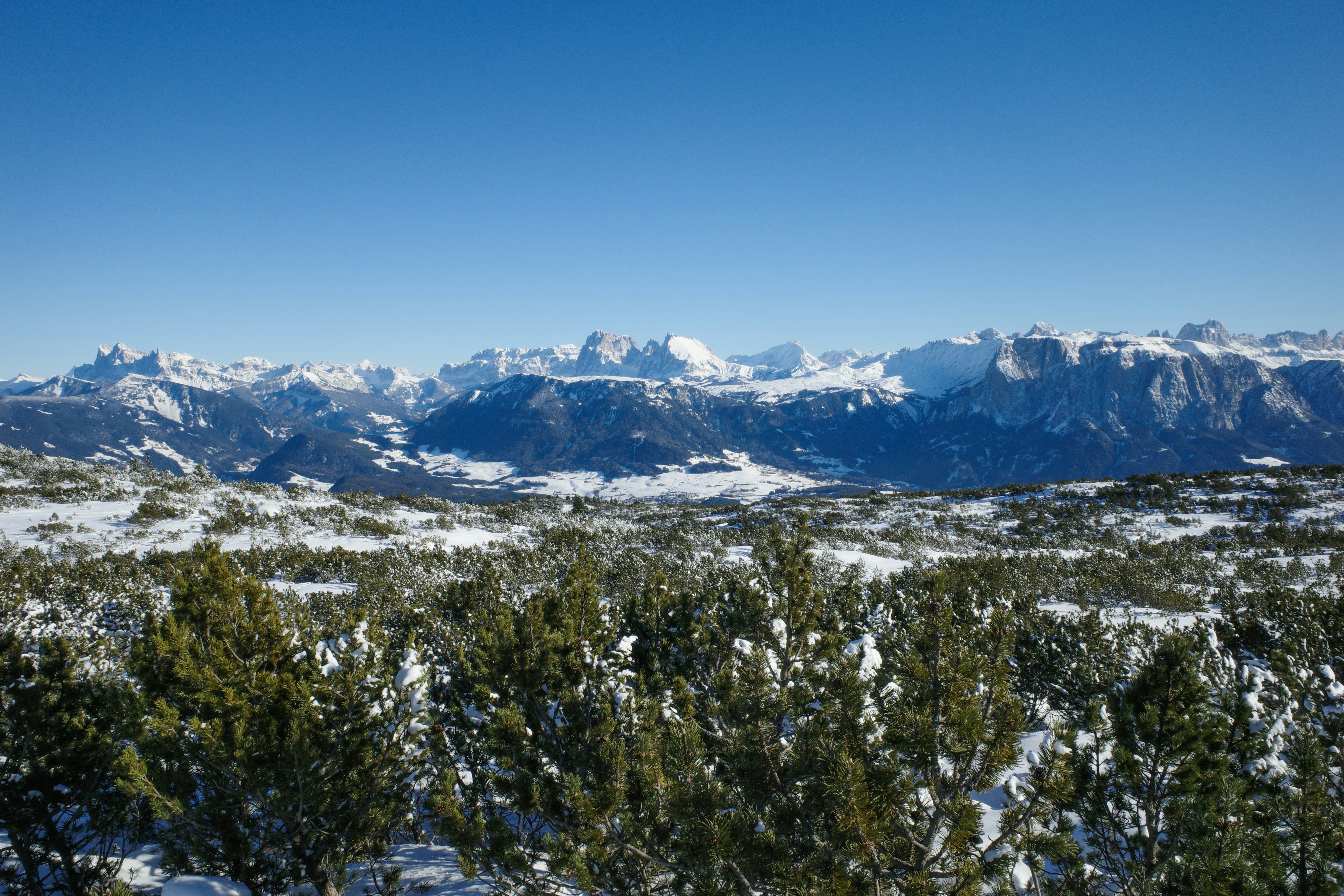 Snowy mountain range under a clear blue sky.
