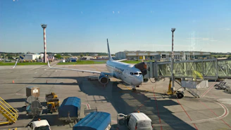 Airplane connected to a jet bridge at airport