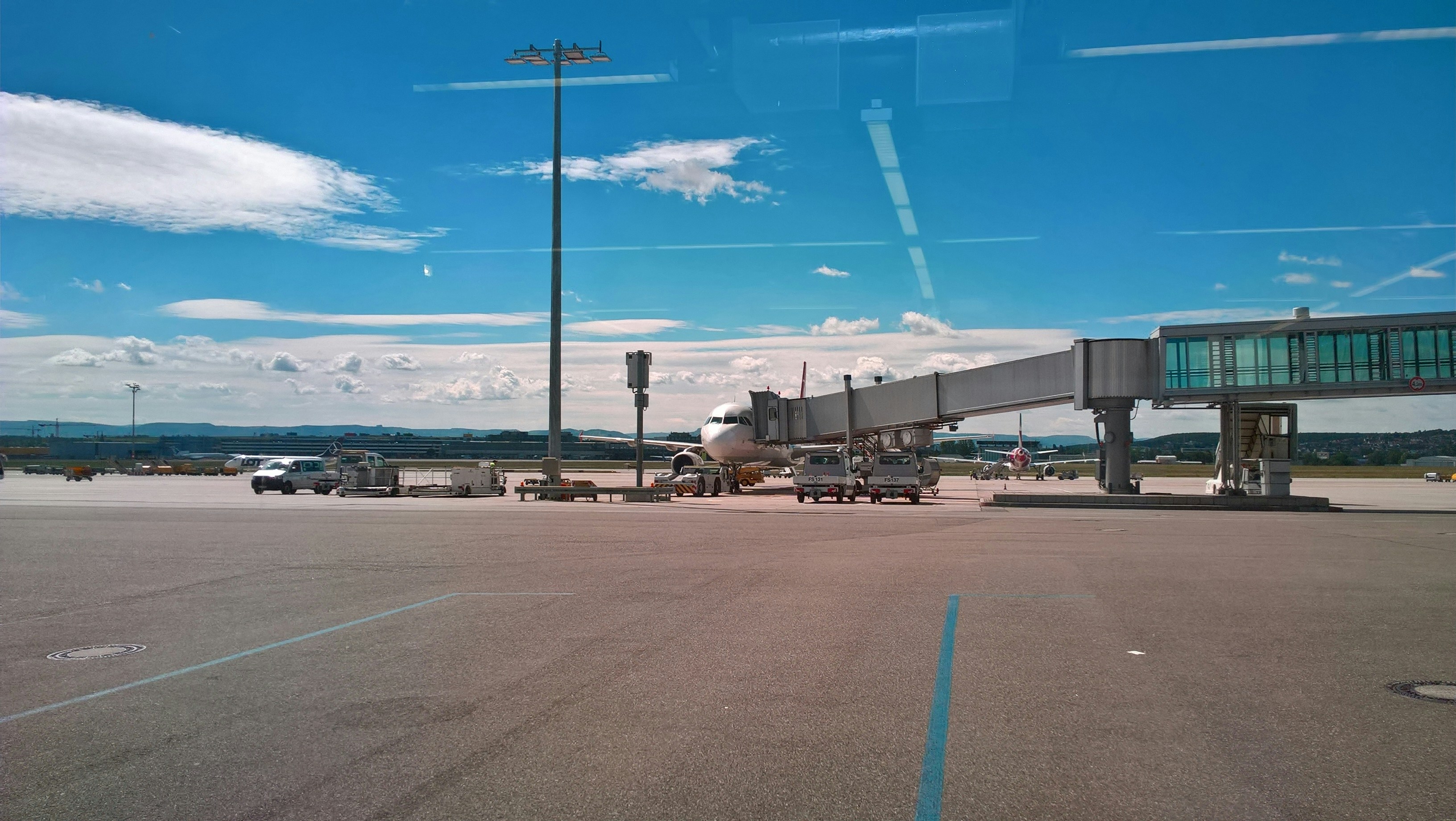 Airplane connected to a jet bridge at airport.